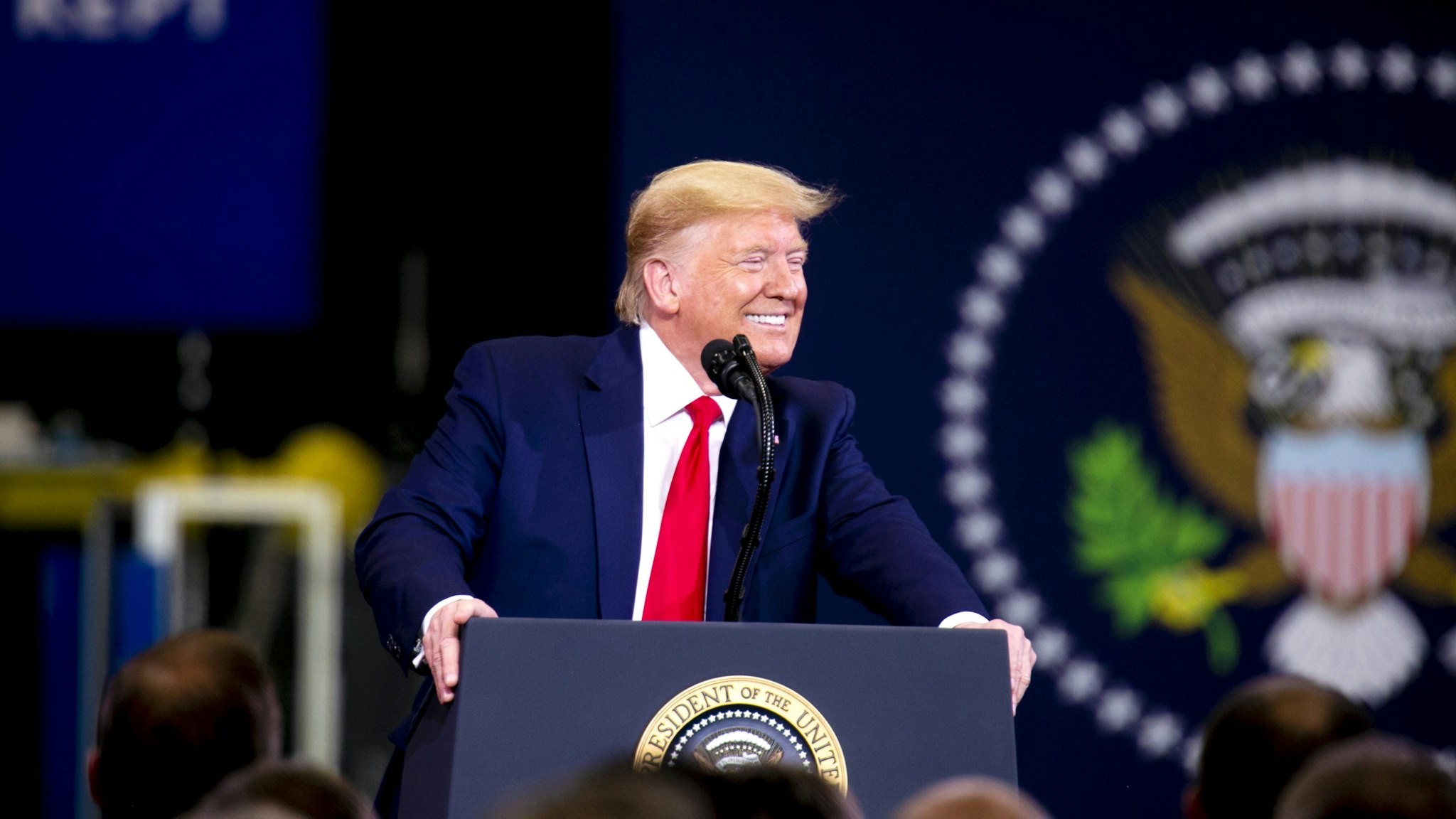 U.S. President Donald Trump smiles while speaking during a visit to a Dana Inc. manufacturing facility in Warren, Michigan, U.S., on Thursday, Jan. 30, 2020. Trump is traveling Thursday to Michigan and Iowa -- where he's expected to tout the new U.S.-Mexico-Canada Agreement (USMCA) trade pact just as Democrats try to win over voters in next weeks Iowa caucuses.