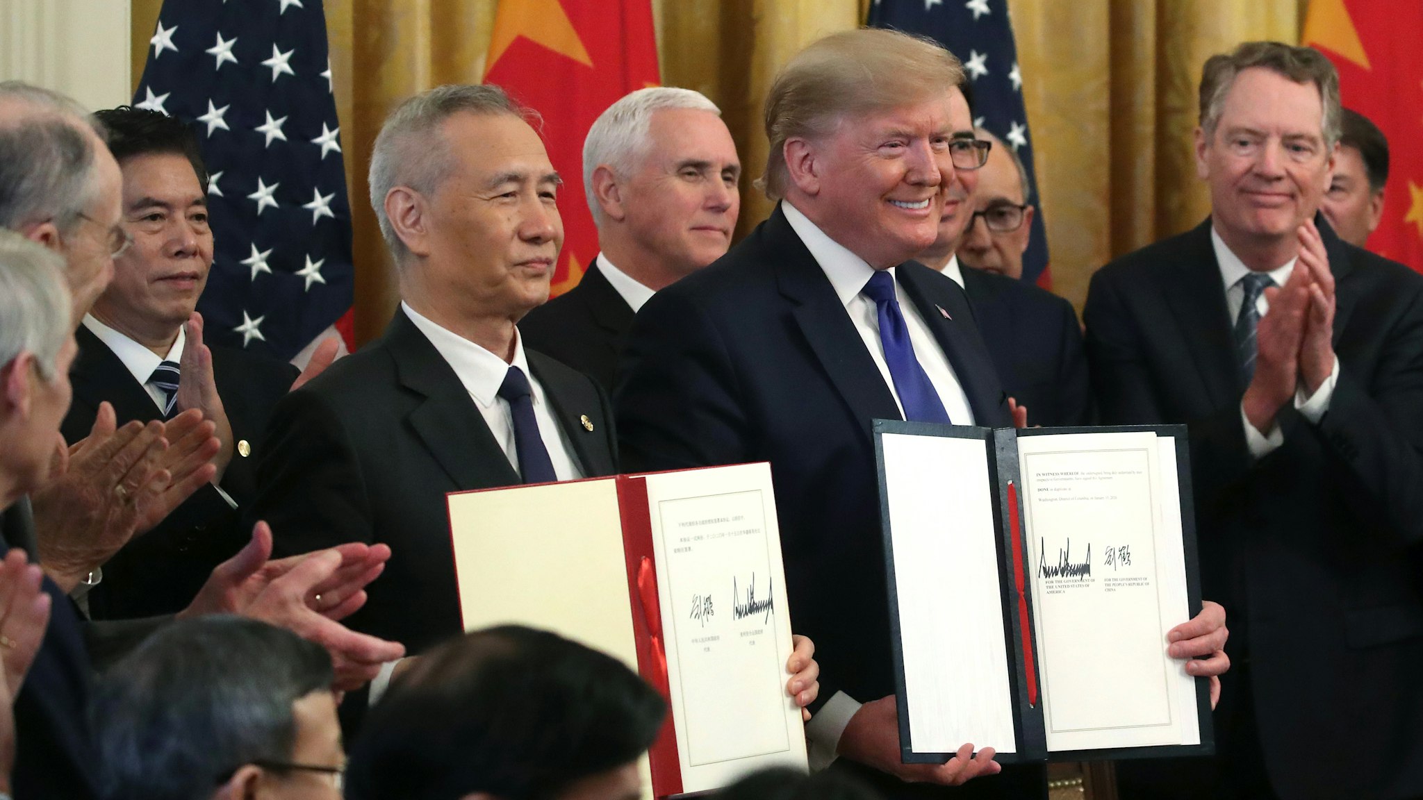WASHINGTON, DC - JANUARY 15: U.S. President Donald Trump and Chinese Vice Premier Liu He, hold up signed agreements of phase 1 of a trade deal between the U.S. and China, in the East Room at the White House, on January 15, 2020 in Washington, DC. Phase 1 is expected to cut tariffs and promote Chinese purchases of U.S. farm, and manufactured goods while addressing disputes over intellectual property.