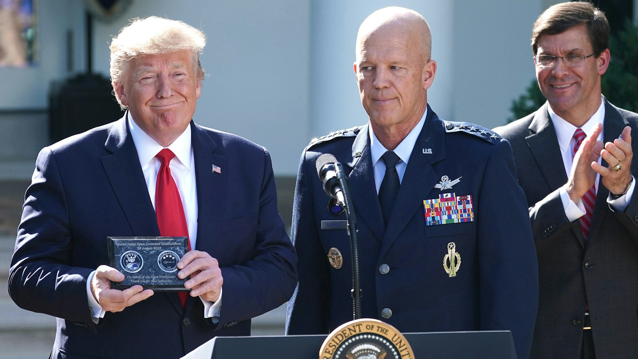 WASHINGTON, DC - AUGUST 29: (L-R) U.S. President Donald Trump, U.S. Air Force Gen. John "Jay" Raymond and Defense Secretary Mark Esper attend an event marking the establishment the U.S. Space Command, the sixth national armed service, in the Rose Garden at the White House August 29, 2019 in Washington, DC. Citing potential threats from China and Russia and the nation’s reliance on satellites for defense operations, Trump said the U.S. needs to launch a 'space force.' Raymond will serve as the first head of Space Command, which will have 87 active units handling operations such as missile warning, satellite surveillance, space control and space support.