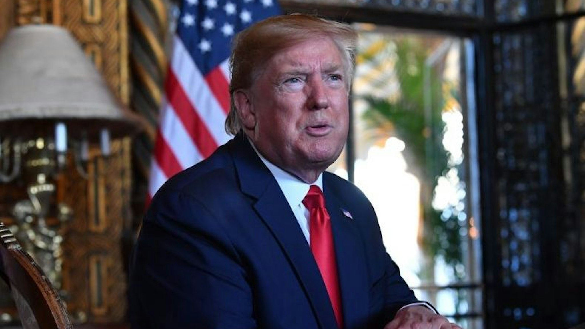 US President Donald Trump answers questions from reporters after making a video call to the troops stationed worldwide at the Mar-a-Lago estate in Palm Beach Florida, on December 24, 2019. (Photo by Nicholas Kamm / AFP)