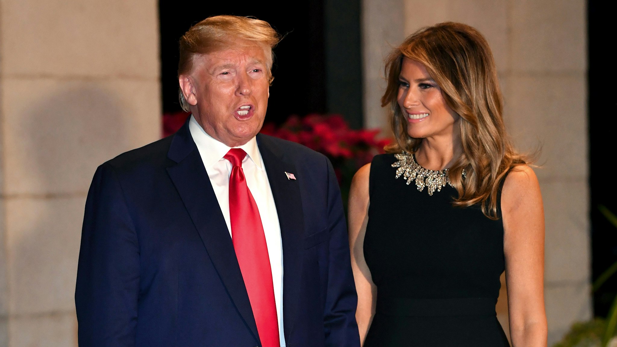US President Donald Trump and First Lady Melania Trump arrive for a Christmas Eve dinner with his family at Mar-A-Lago in Palm Beach, Florida on December 24, 2019.