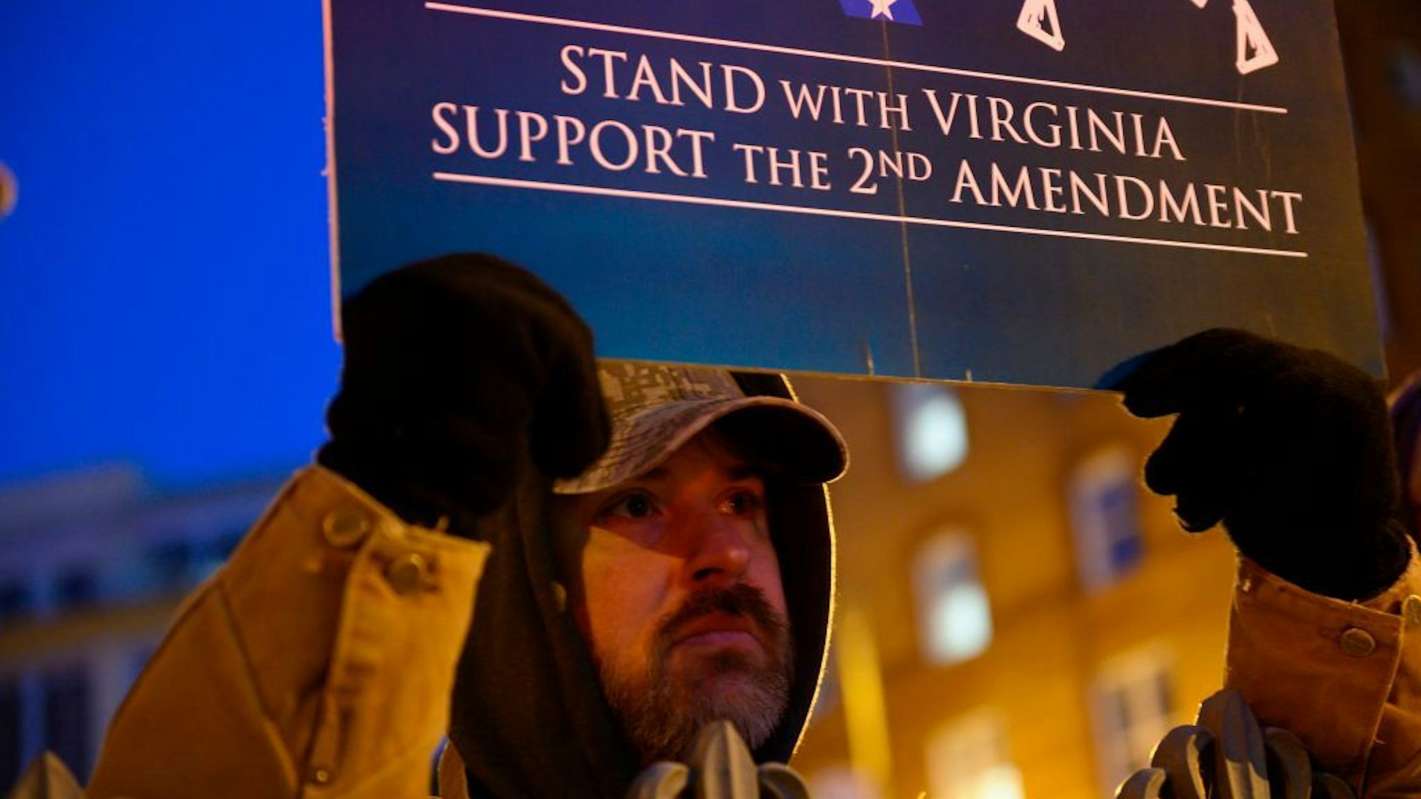 A protestor holds a sign in front of the Virginia State Capitol building in Richmond, Virginia on January 20, 2020. - Thousands of gun rights supporters descended for a rally in the grounds of the State Capitol under heavy surveillance after authorities were forced to declare a state of emergency for fear of violence by far-right groups. (Photo by Roberto SCHMIDT / AFP)