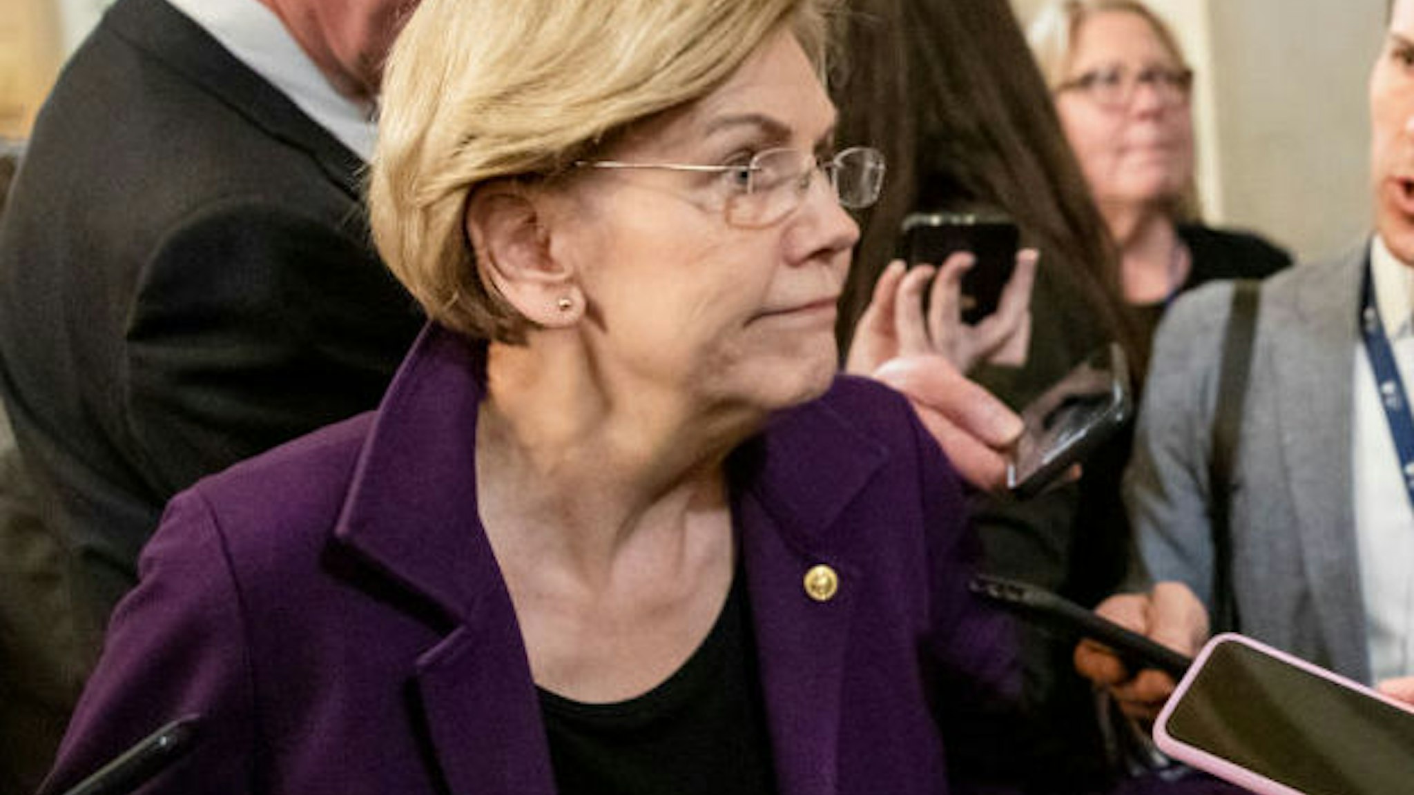 WASHINGTON, DC - JANUARY 27: Democratic Presidential Candidate Senator Elizabeth Warren answers questions from the press as she leaves after the Senate impeachment trial of President Donald Trump was adjourned for the day on January 27, 2020 in Washington, DC. The defense team continues its arguments on the sixth day of the Senate impeachment trial of President Trump. It has been reported that Senator Pat Toomey has been discussing that a "one-for-one" witness deal be proposed to Senate Democrats after the Presidents legal defense team concludes their opening arguments on Tuesday.
