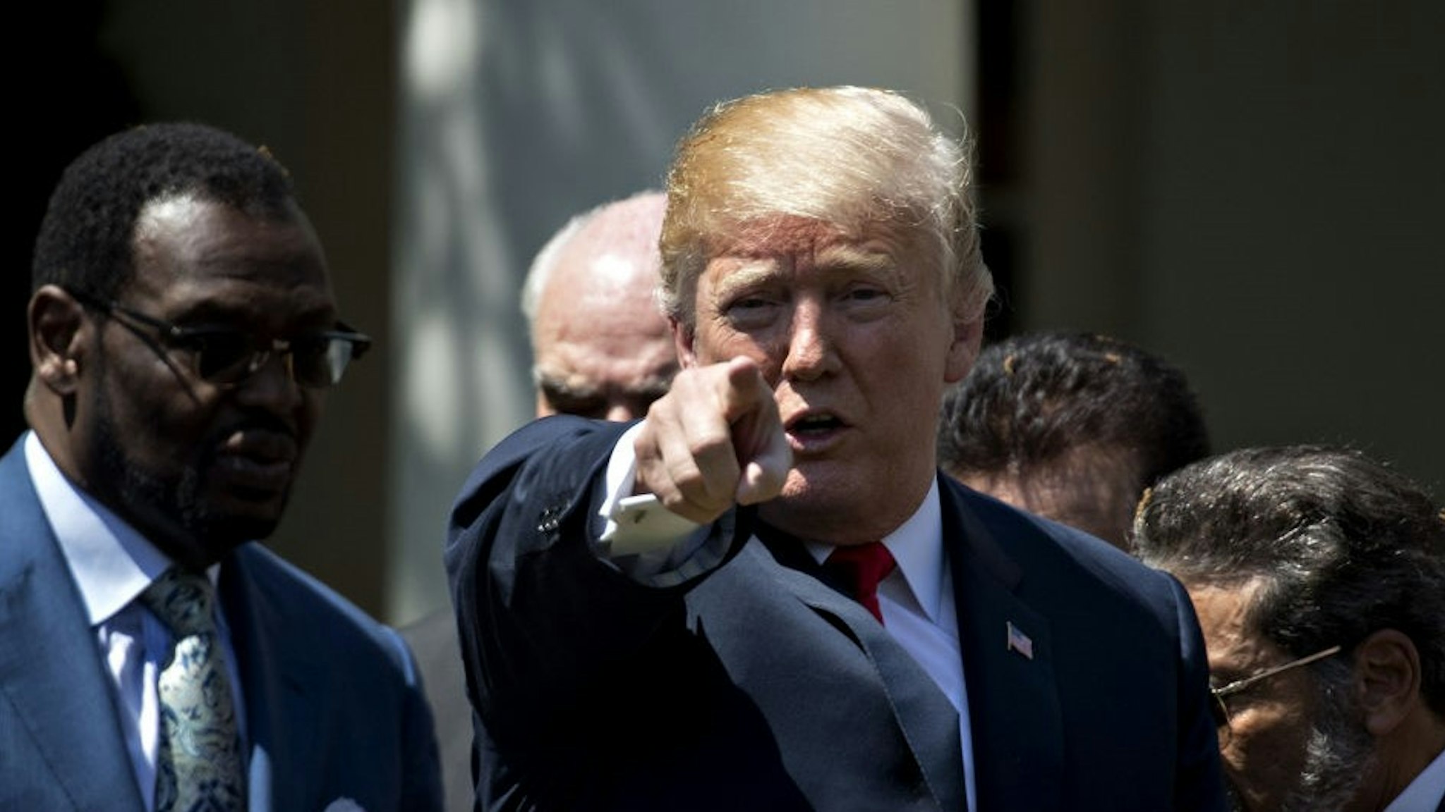 U.S. President Donald Trump points to the audience after signing an executive order entitled Establishment of a White House Faith and Opportunity Initiative during a National Day of Prayer ceremony in the Rose Garden of the White House in Washington, D.C., U.S. on Thursday, May 3, 2018. Congress in 1988 called on the president to issue each year a proclamation designating the first Thursday in May as a National Day of Prayer.