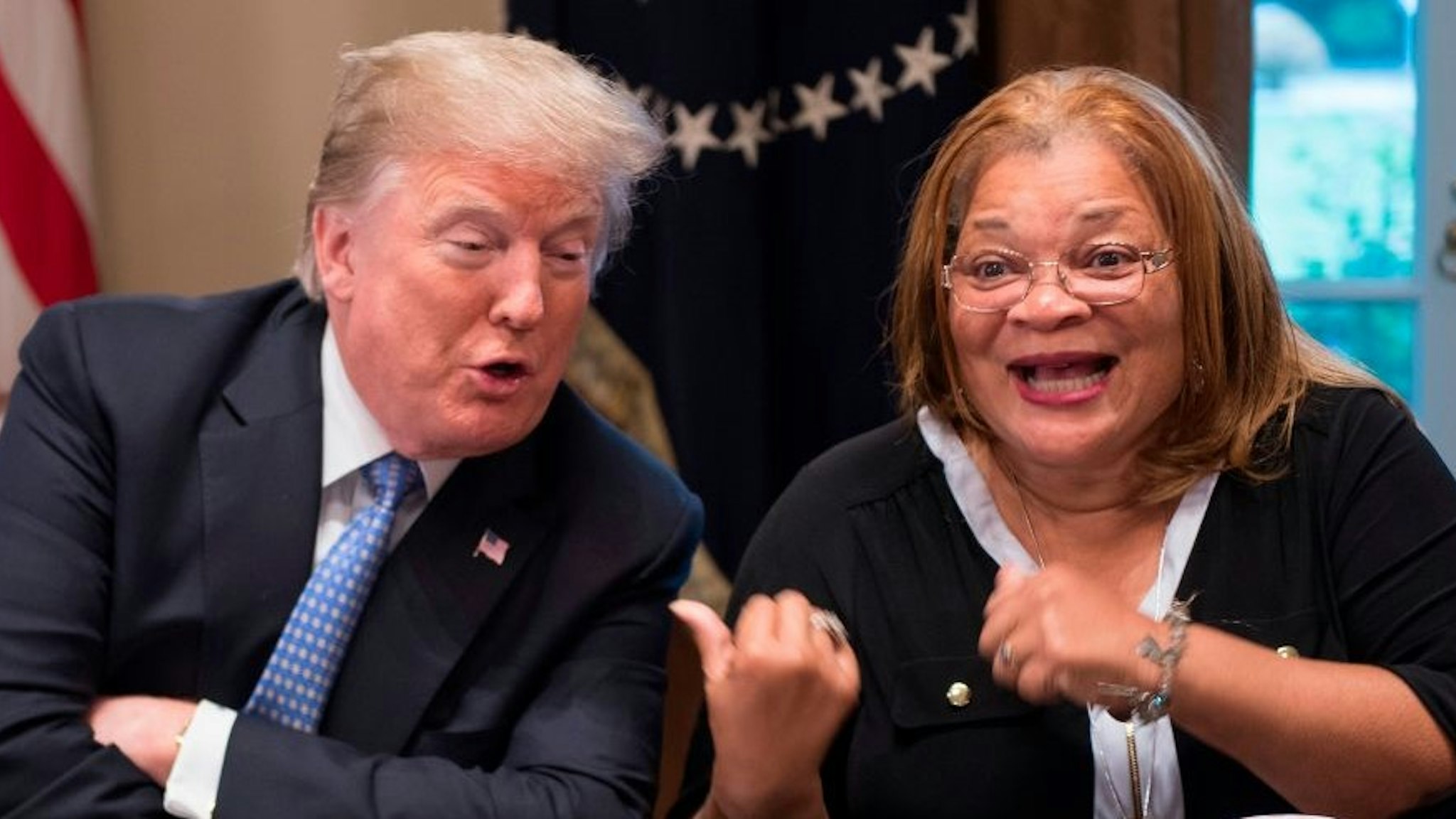 TOPSHOT - US President Donald Trump responds to Dr. Alveda King, niece of Dr. Martin Luther King Jr., during a meeting with inner city pastors at the White House in Washington, DC,on August 1, 2018. - President Trump delivered remarks at the roundtable discussion with several inner city pastors, and discussed the Administrations efforts on prison reform and other policy initiatives to improve Americans in inner cities.
