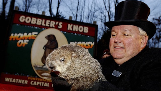 PUNXSUTAWNEY, PA - FEBRUARY 2: Official groundhog handler Bill Deeley holds Punxsutawney Phil on February 2, 2006 in Punxsutawney, Pennsylvania. Every February 2, people gather at Gobbler's Knob, a wooded knoll just outside of Punxsutawney to watch Punxsutawney Phil look for his shadow. If he sees his shadow, it means six more weeks of winter. If he does not see his shadow, it means spring is just around the corner. The legend of Groundhog Day is based on an old Scottish couplet: "If Candlemas Day is bright and clear, there'll be two winters in the year." (Photo by J