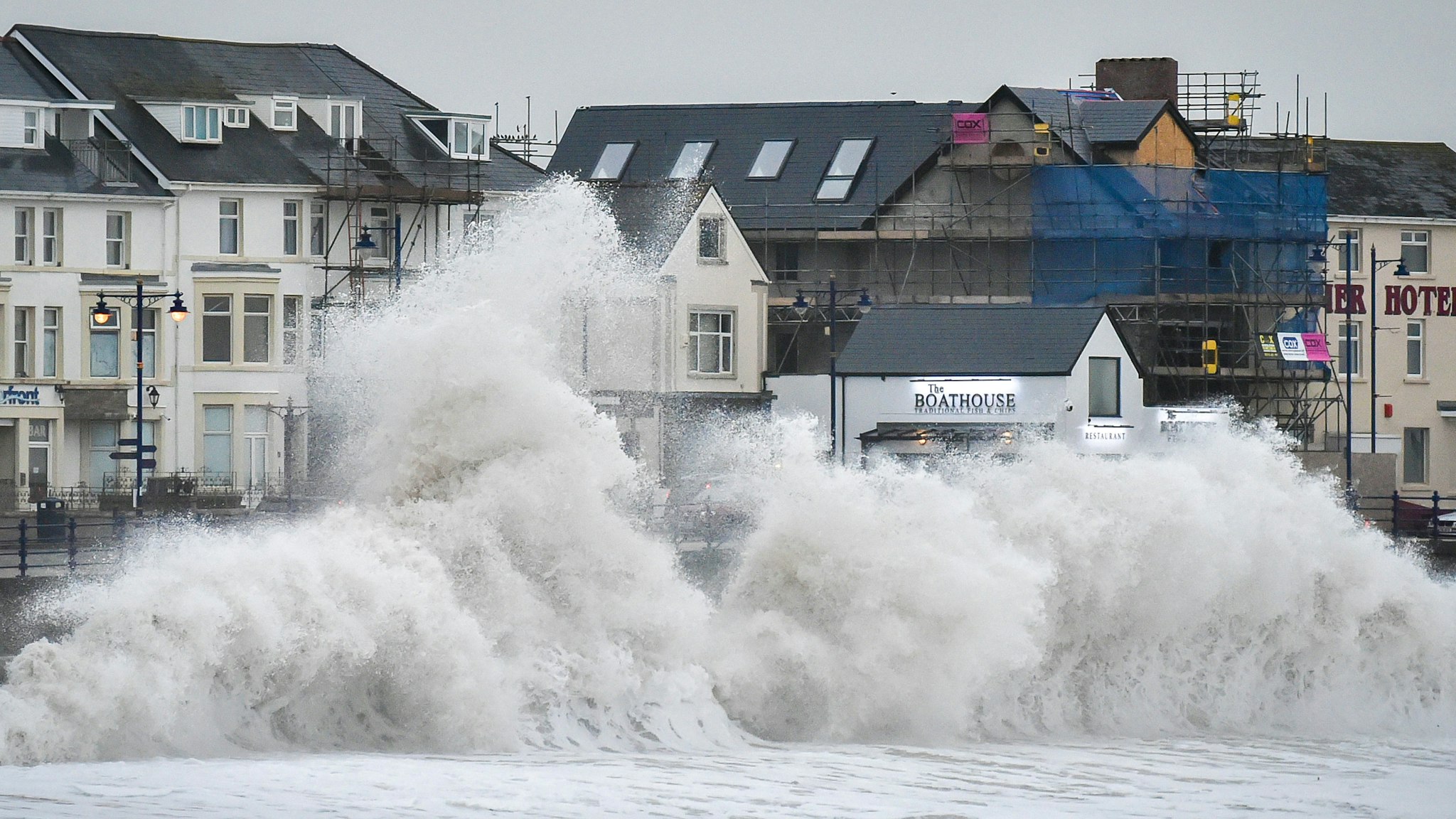 Huge waves hit the sea wall in Porthcawl, Wales, as gales of up to 80mph from Storm Brendan caused disruption around the UK.