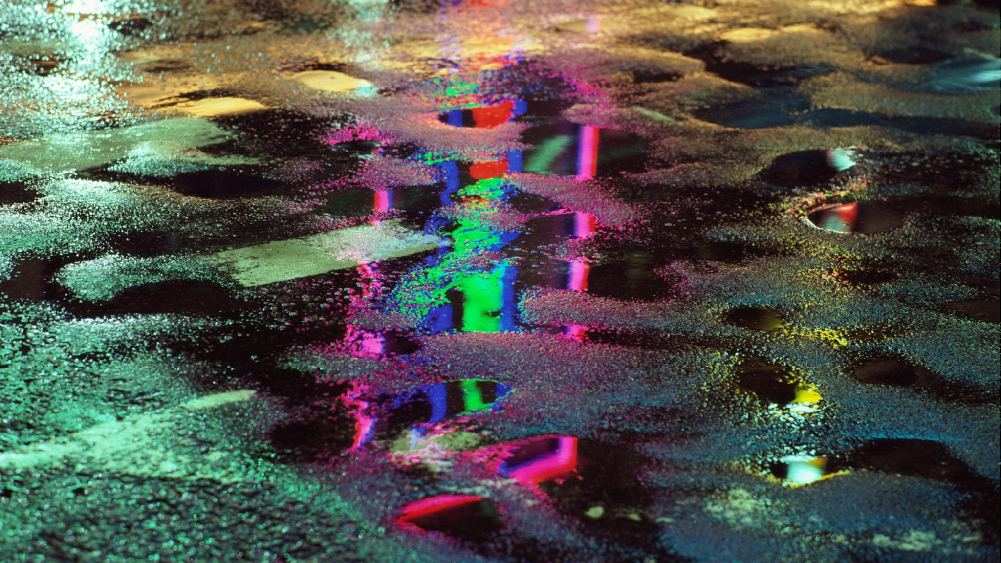 The bright lights of the Ginza district of Tokyo, reflected in a wet road surface, Japan, June 1984.