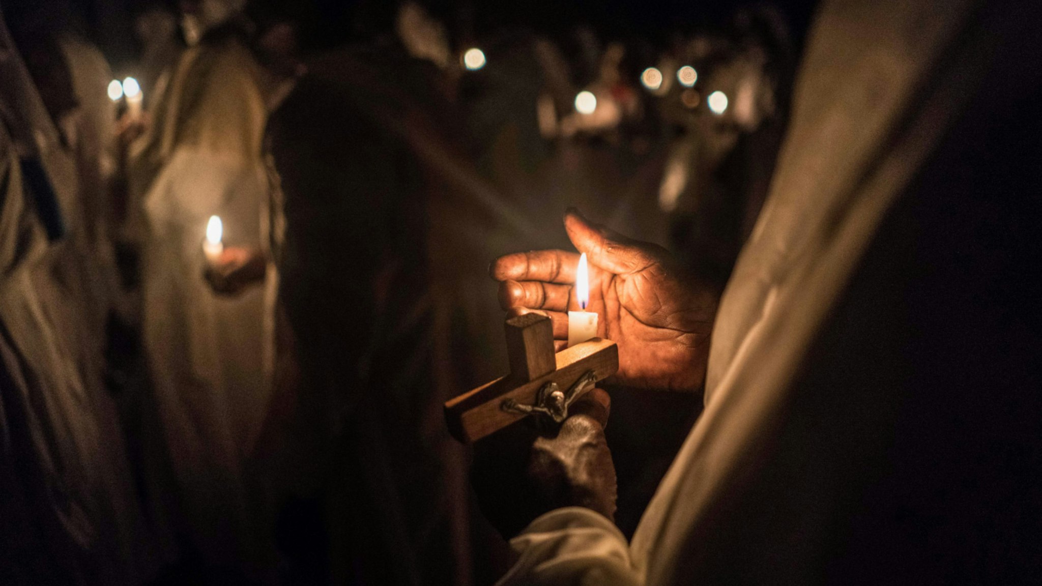 Believers of Legio Maria of African Church Mission hold candles during their overnight Christmas Mass at the church near Ugunja, the western part of Kenya, early December 25, 2017.