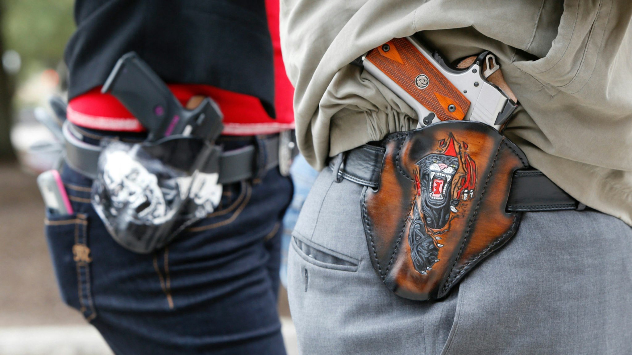 Art and Diana Ramirez of Austin with their pistols in custom-made holsters during and open carry rally at the Texas State Capitol on January 1, 2016 in Austin, Texas.