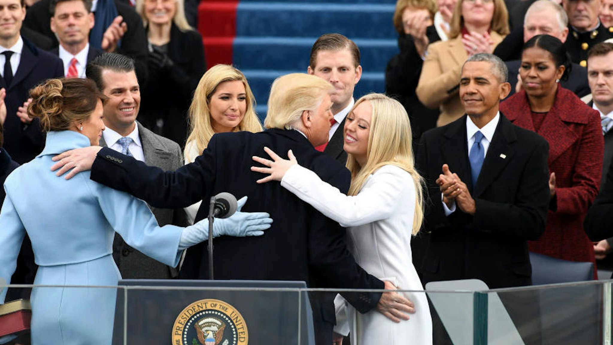U.S. President Donald Trump embraces his family during the 58th presidential inauguration in Washington, D.C., U.S., on Friday, Jan. 20, 2017. Monday, January 20, 2020, marks the third anniversary of U.S. President Donald Trump's inauguration. Our editors select the best archive images looking back over Trump’s term in office. Photographer: Pat Benic/Pool via Bloomberg