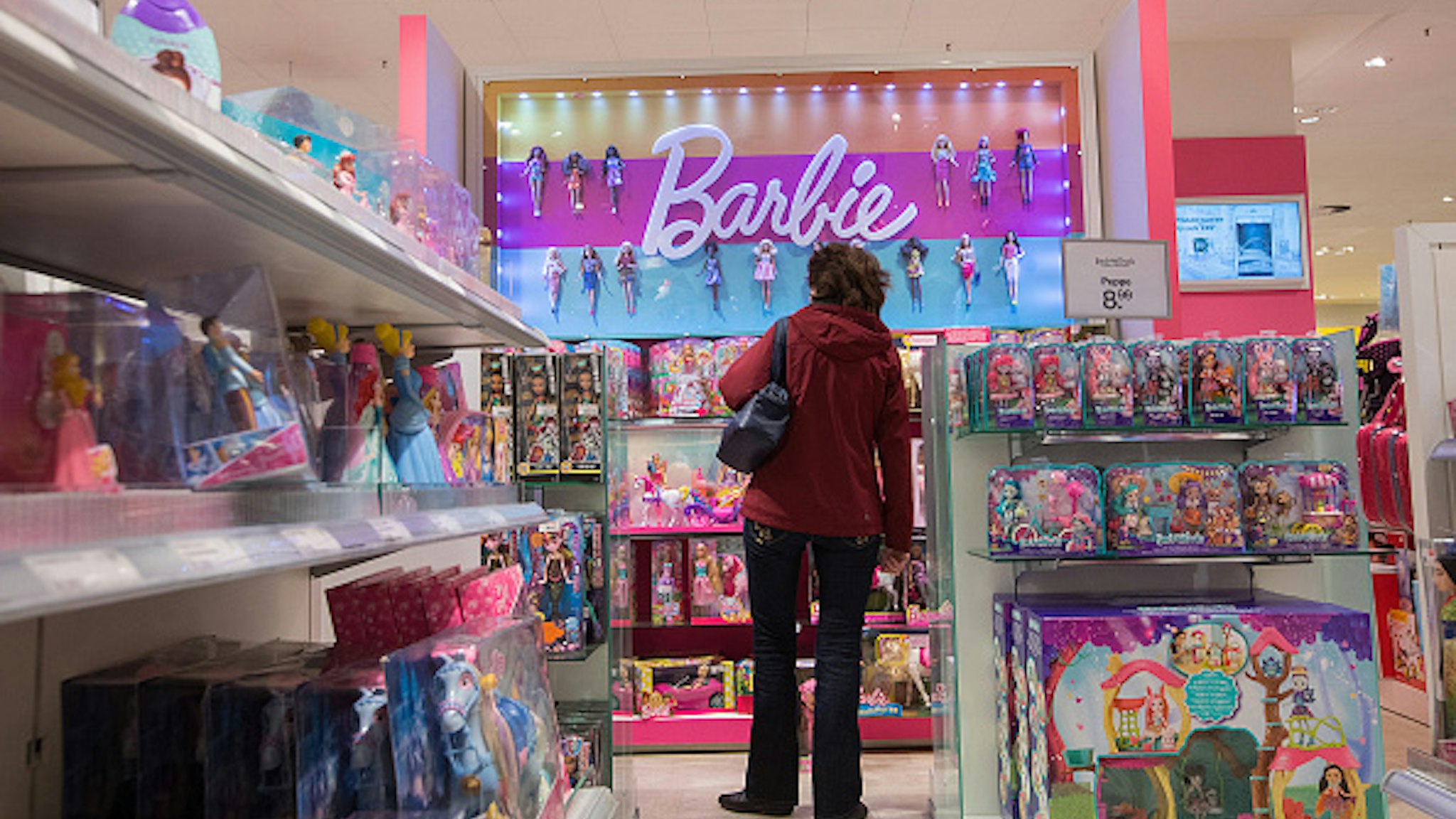 A customer stands beside a Barbie toy doll display inside a Galeria Kaufhof department store, operated by Hudson's Bay Co., in Berlin, Germany, on Wednesday, Dec. 6, 2017. Austrian property developer Rene Benko is taking a second run at consolidating Germany's dusty department stores, making an unsolicited bid for the Kaufhof chain now owned by Toronto-based Hudson's Bay.