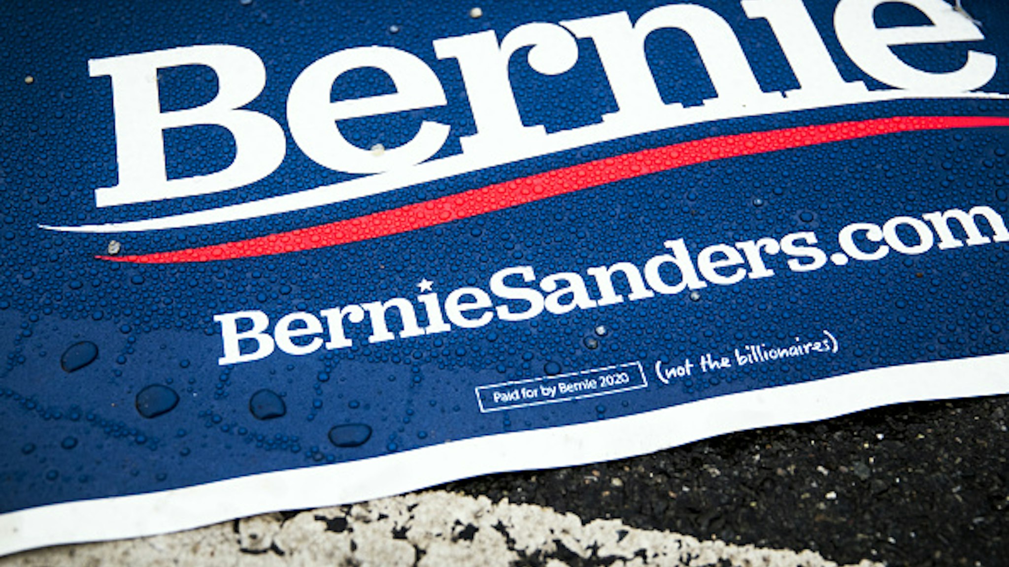 A campaign sign for Senator Bernie Sanders, an Independent from Vermont and 2020 presidential candidate, lays on the ground in Portsmouth, New Hampshire, U.S., on Tuesday, Feb. 11, 2020. Sanders has opened a 10-point lead over Joe Biden in the Democratic presidential primary, according to a national poll released Tuesday, highlighting how the former vice president's fourth-place showing in Iowa has reshaped the nomination fight.