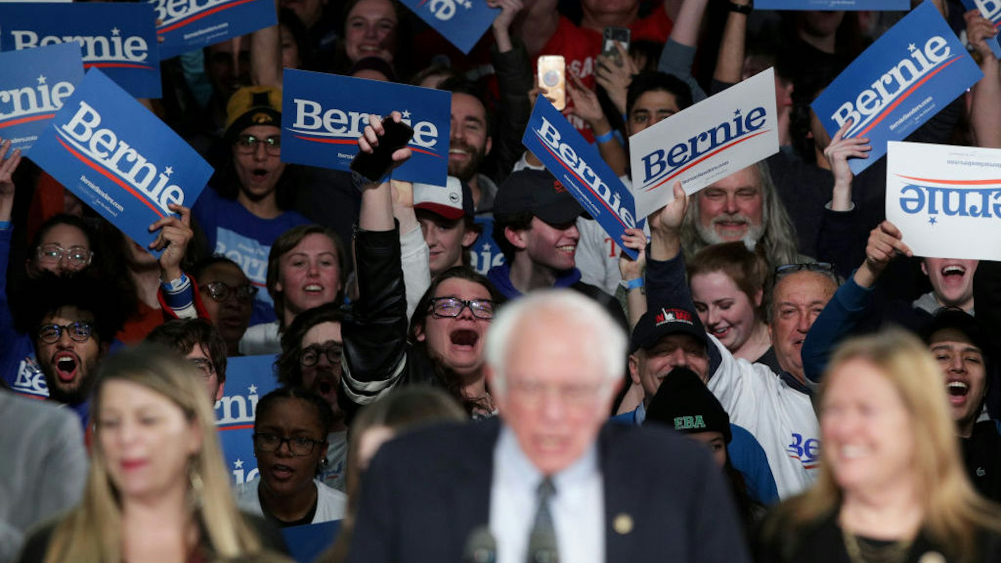 Supporters of Democratic presidential candidate Sen. Bernie Sanders (I-VT) cheer as he speaks during his caucus night watch party on February 03, 2020 in Des Moines, Iowa. Iowa is the first contest in the 2020 presidential nominating process with the candidates then moving on to New Hampshire. (Photo by Alex Wong/Getty Images)