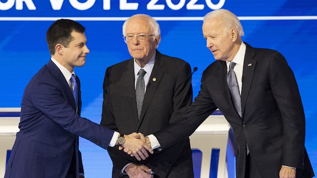 Pete Buttigieg, former mayor of South Bend and 2020 presidential candidate, left, shakes hands with Former Vice President Joe Biden, as Senator Bernie Sanders, an Independent from Vermont, stands on stage ahead of the Democratic presidential debate at Saint Anselm College in Manchester, New Hampshire, U.S., on Friday, Feb. 7, 2020. The New Hampshire debates often mark a turning point in a presidential campaign, as the field of candidates is winnowed and voters begin to pay closer attention.