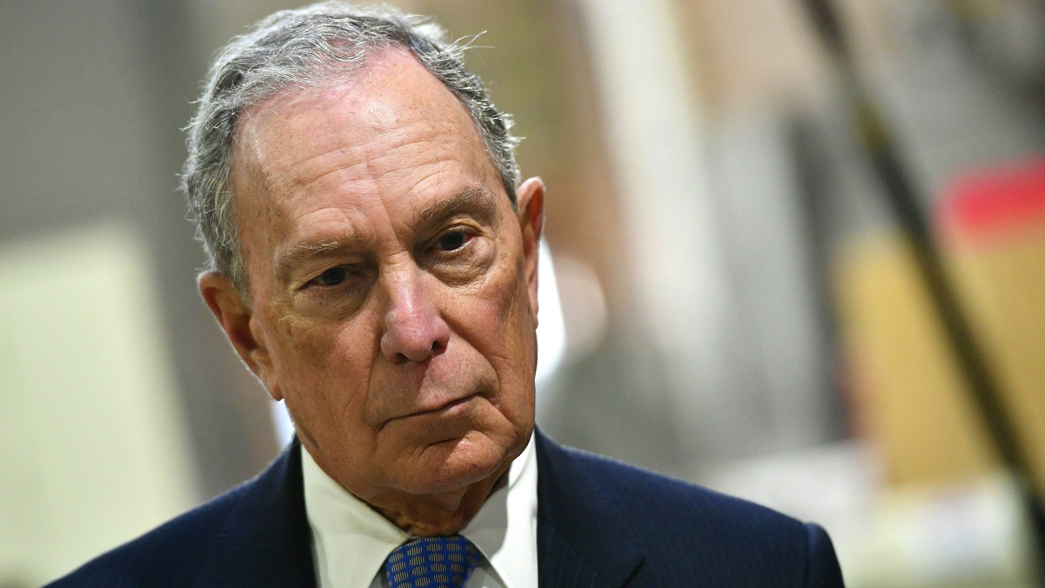 US Democratic Presidential candidate, Mike Bloomberg, looks on while visiting 'Building Momentum', a veteran owned business in Alexandria, Virginia on February 7, 2020.