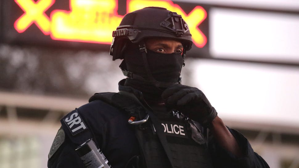 Immigrant Caravan Members Continue To Gather At U.S.-Mexico Border TIJUANA, MEXICO - DECEMBER 01: U.S. Customs and Border Protection (CBP) officers block the Otay Mesa port of entry from Mexico into the United States early on December 1, 2018 as seen from Tijuana, Mexico. CPB officers staged the crowd control training exercise, using riot gear and fake tear gas, in advance of a potential attempt by members of the migrant caravan to rush the border crossing.