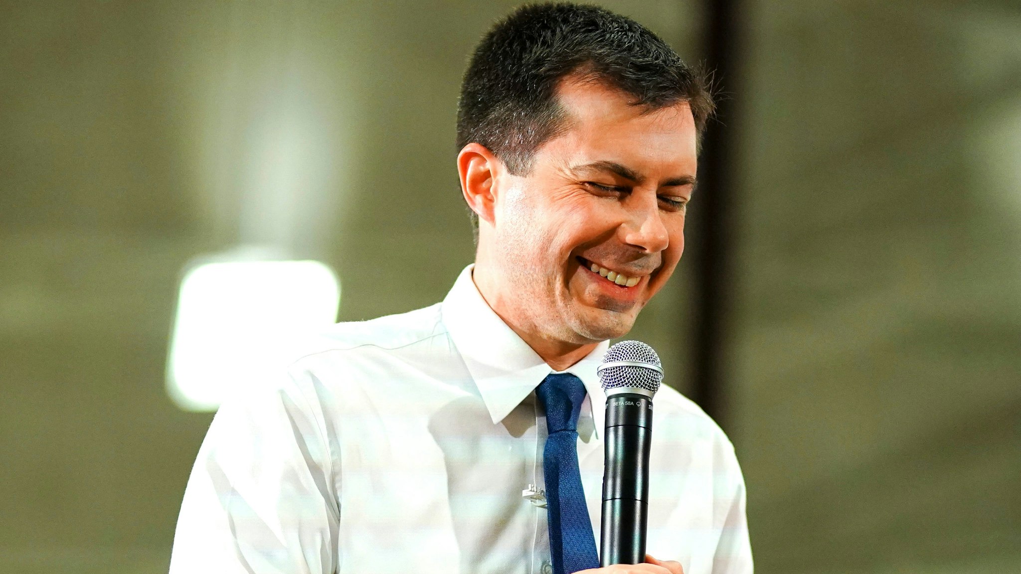 Pete Buttigieg, former mayor of South Bend and 2020 presidential candidate, laughs while speaking at a campaign event in Des Moines, Iowa, U.S., on Sunday, Feb. 2, 2020. Buttigieg's top campaign staff took veiled shots at Iowa front-runners Bernie Sanders and Joe Biden, reflecting the candidate's argument that it's time for a fresh start in Washington.