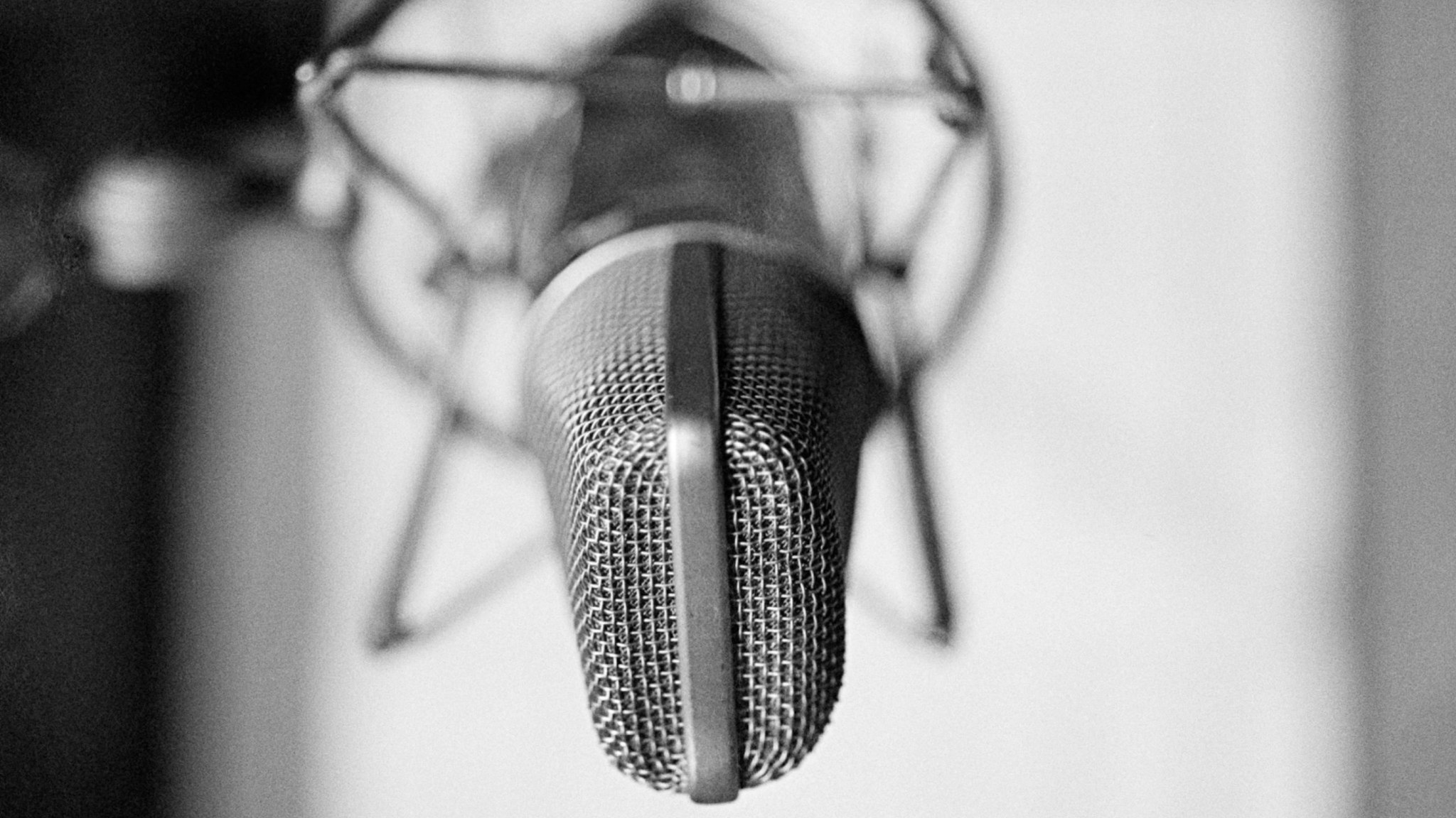 General view of a condenser microphone in a shock mount in a recording studio, circa 1980.