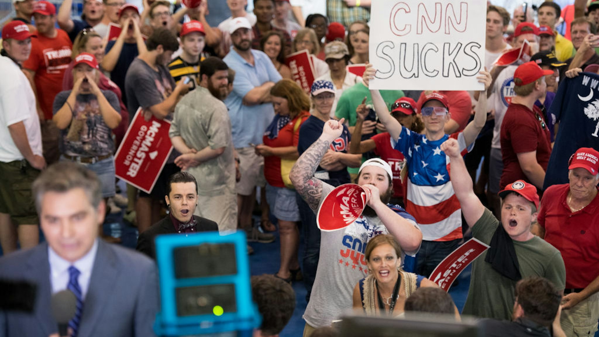 People shout behind CNN reporter Jim Acosta before a campaign rally for South Carolina Governor Henry McMaster featuring President Donald Trump at Airport High School June 25, 2018 in West Columbia, South Carolina. (Photo by Sean Rayford/Getty Images)