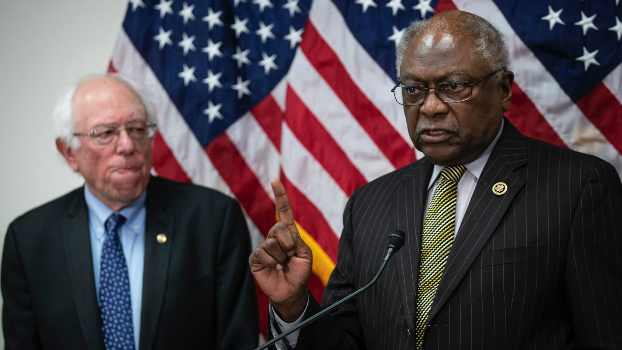 Sen. Bernie Sanders (I-VT) looks on as Rep. James Clyburn (D-SC) speaks during a press conference to announce legislation to extend and expand funding for community health centers and the National Health Service Corps, at the U.S. Capitol on March 28, 2019 in Washington, DC.