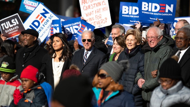 Democratic presidential candidates, Rep. Tulsi Gabbard (D-HI), left, former Vice President Joe Biden, Sen. Amy Klobuchar (D-MN), Sen. Elizabeth Warren (D-MA), and Sen. Bernie Sanders (I-VT), right, march on Main St. to the King Day at the Dome event with Democratic candidate for U.S. Senate Jaime Harrison, far left, on January 20, 2020 in Columbia, South Carolina. The event, first held in 2000 in opposition to the display of the Confederate battle flag at the statehouse, attracted more than a handful of Democratic presidential candidates to the early primary state. (Photo by Sean Rayford/Getty Images)