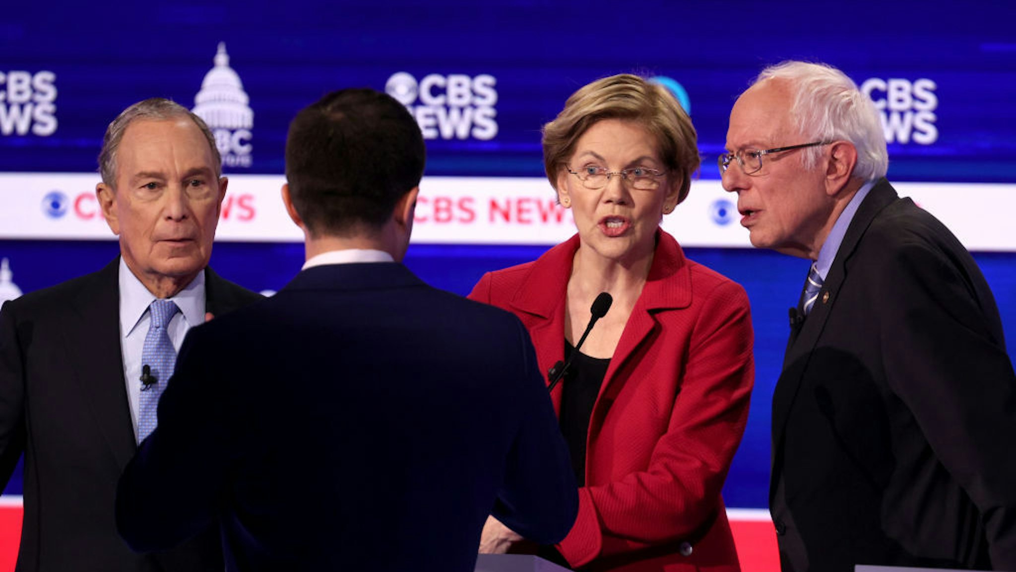 Democratic presidential candidates former New York City Mayor Mike Bloomberg, former South Bend, Indiana Mayor Pete Buttigieg, Sen. Elizabeth Warren (D-MA) and Sen. Bernie Sanders (I-VT) interact in a break during the Democratic presidential primary debate at the Charleston Gaillard Center on February 25, 2020 in Charleston, South Carolina. Seven candidates qualified for the debate, hosted by CBS News and Congressional Black Caucus Institute, ahead of South Carolina‚Äôs primary in four days. (Photo by Win McNamee/Getty Images)