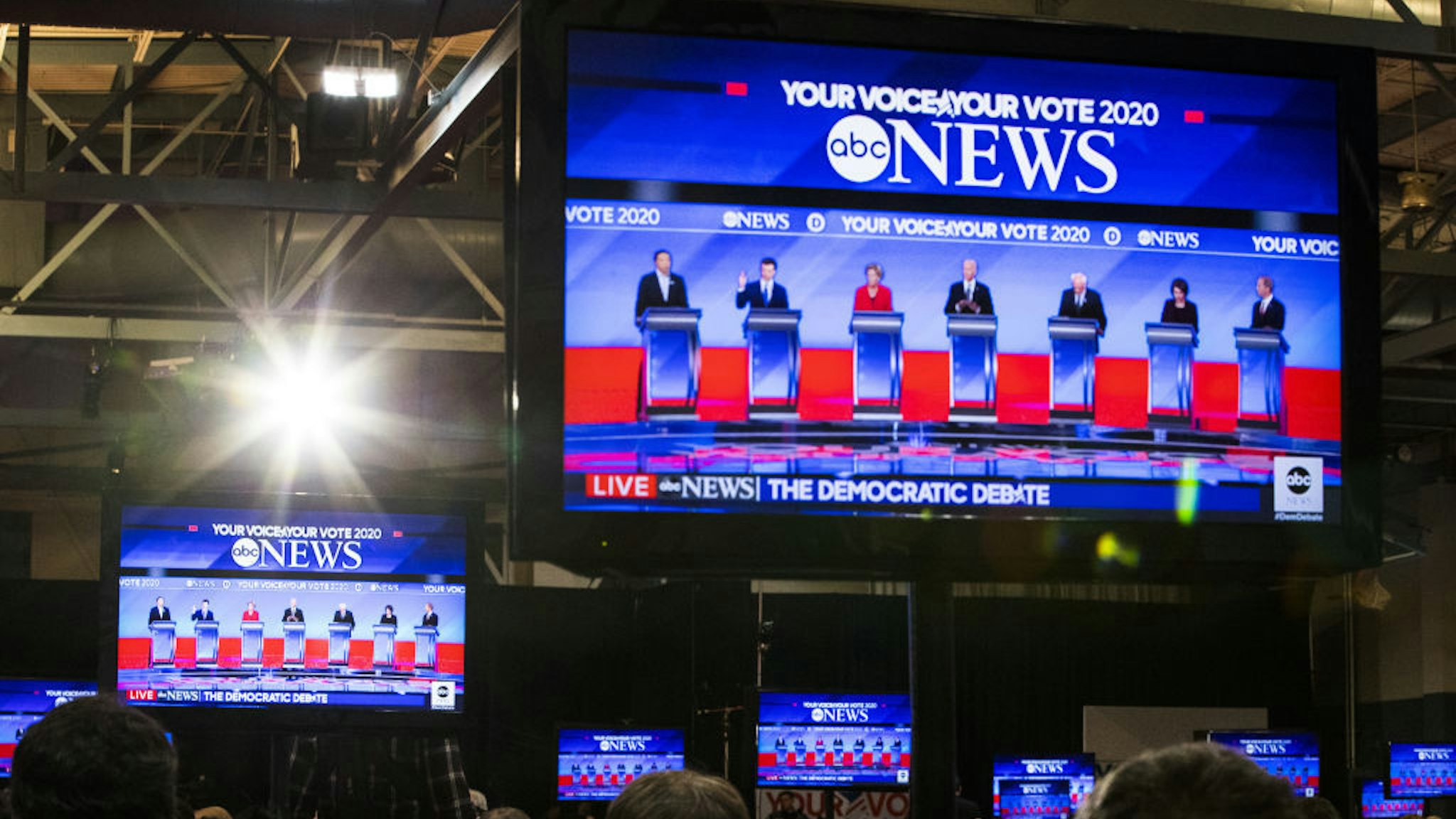 2020 Democratic presidential candidates are seen on television screens in the spin room during the Democratic presidential debate at Saint Anselm College in Manchester, New Hampshire, U.S., on Friday, Feb. 7, 2020. The New Hampshire debates often mark a turning point in a presidential campaign, as the field of candidates is winnowed and voters begin to pay closer attention. Photographer: Adam Glanzman/Bloomberg