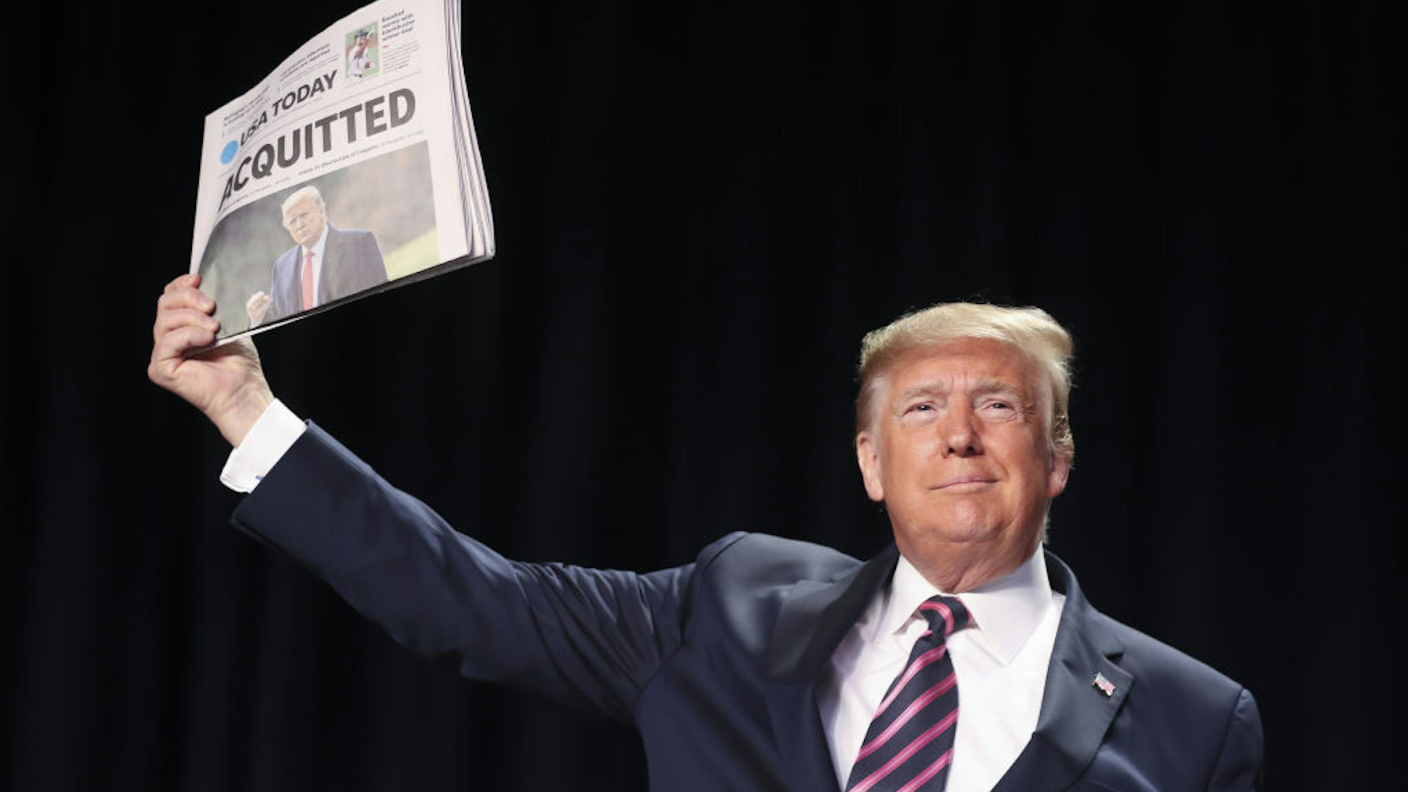 U.S. President Donald Trump holds up a copy of USA Today newspaper with a banner headline that reads "Acquitted" as he arrives to annual National Prayer Breakfast at the Washington Hilton in Washington, D.C., U.S., on Thursday, Feb. 6, 2020. Trump used the annual National Prayer Breakfast Thursday to attack his political enemies after his partisan acquittal of impeachment charges. Photographer: Oliver Contreras/Sipa/Bloomberg