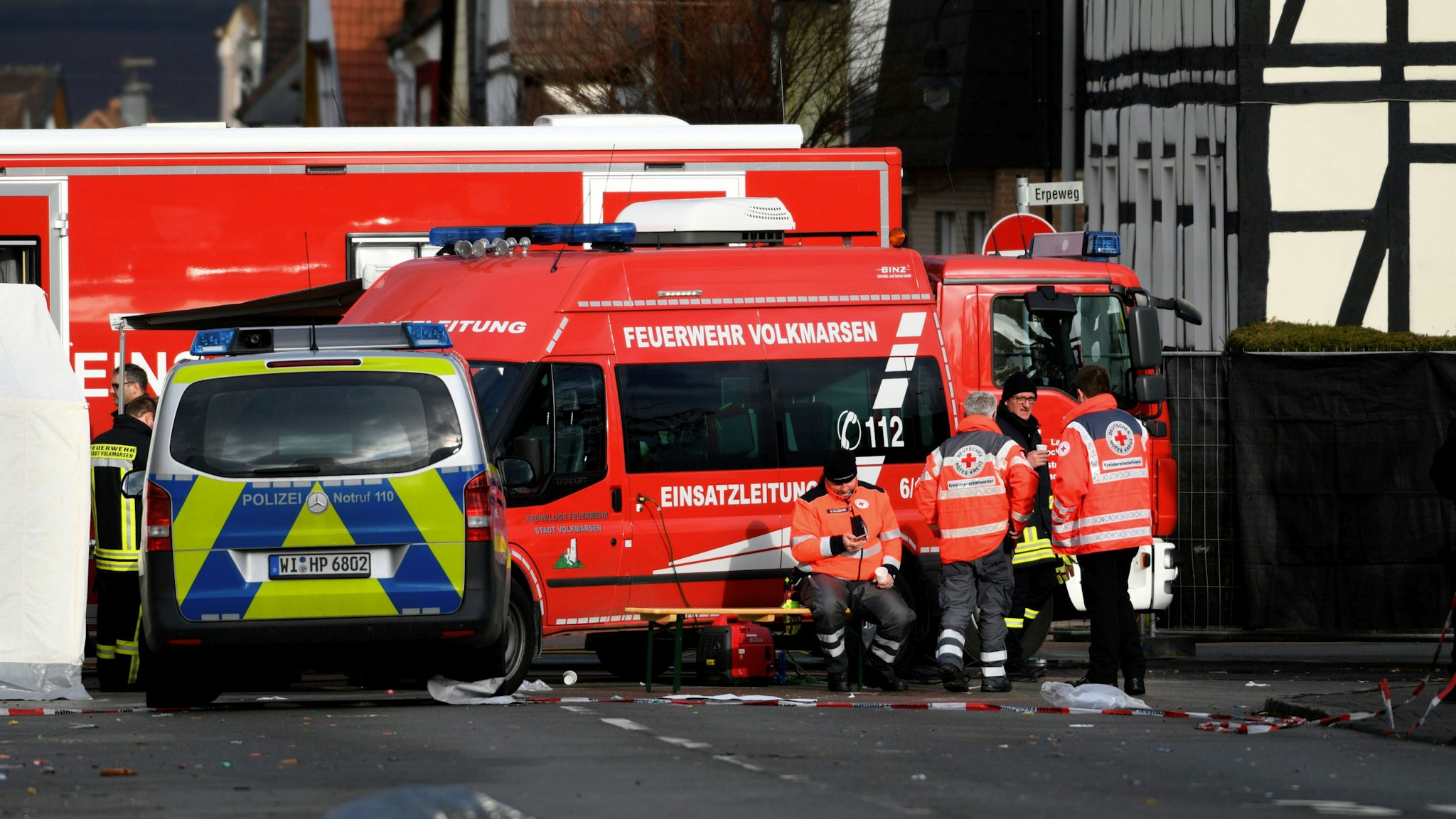 Vehicles of the police and the fire brigades stand at the site where a man who drove into a carnival procession, on February 25, 2020 in Volkmarsen near Kassel, central Germany. - A car that rammed into a carnival procession in Volkmarsen on Rose Monday, February 24, 2020, injured 52 people, including 18 children, police said, adding that the perpetrator's motive remains unclear.
