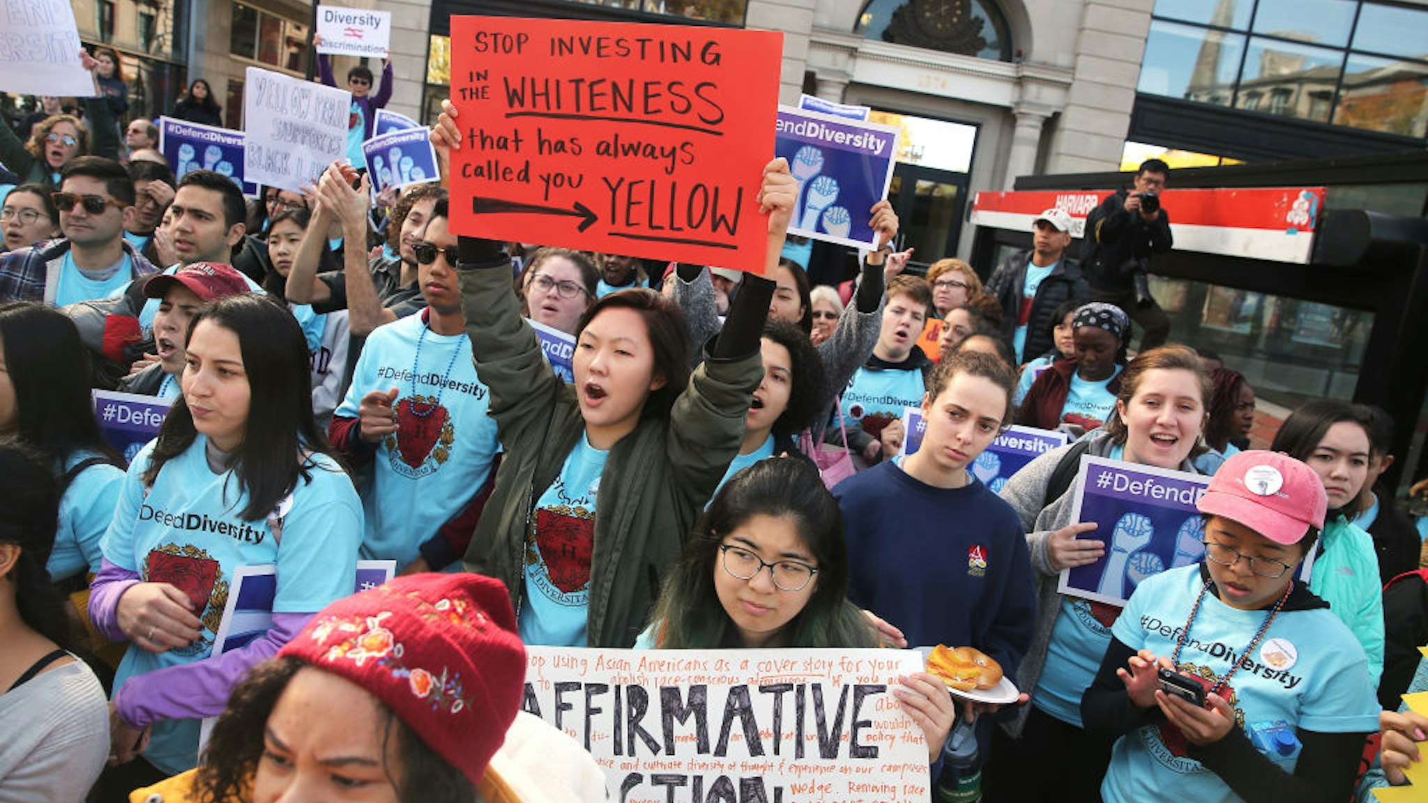 Sarah Chung, a junior at Harvard University, holding orange sign at center, participates in a "defend diversity" pro-affirmative-action rally in Harvard Square in Cambridge, MA on Oct. 14,. 2018.