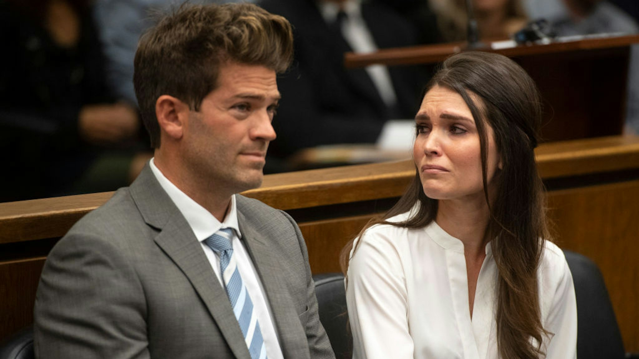 Dr. Grant Robicheaux and his girlfriend Cerissa Riley listen during their arraignment at the Harbor Justice Center in Newport Beach, CA on Wednesday, October 17, 2018.