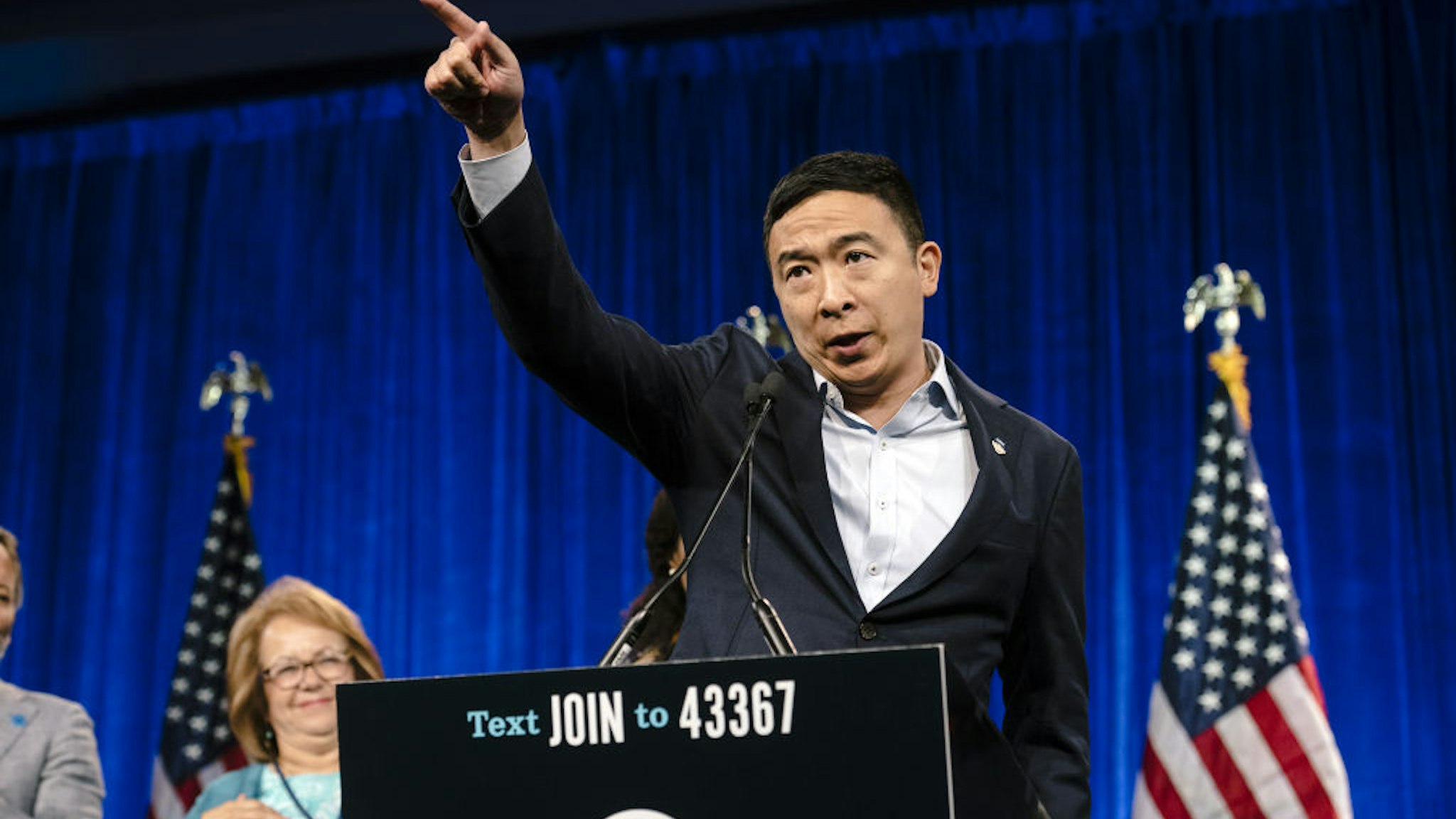 Andrew Yang, founder of Venture for America and 2020 Democratic presidential candidate, gestures while speaking during the Democratic National Committee (DNC) Summer Meeting in San Francisco, California, U.S., on Friday, Aug. 23, 2019.