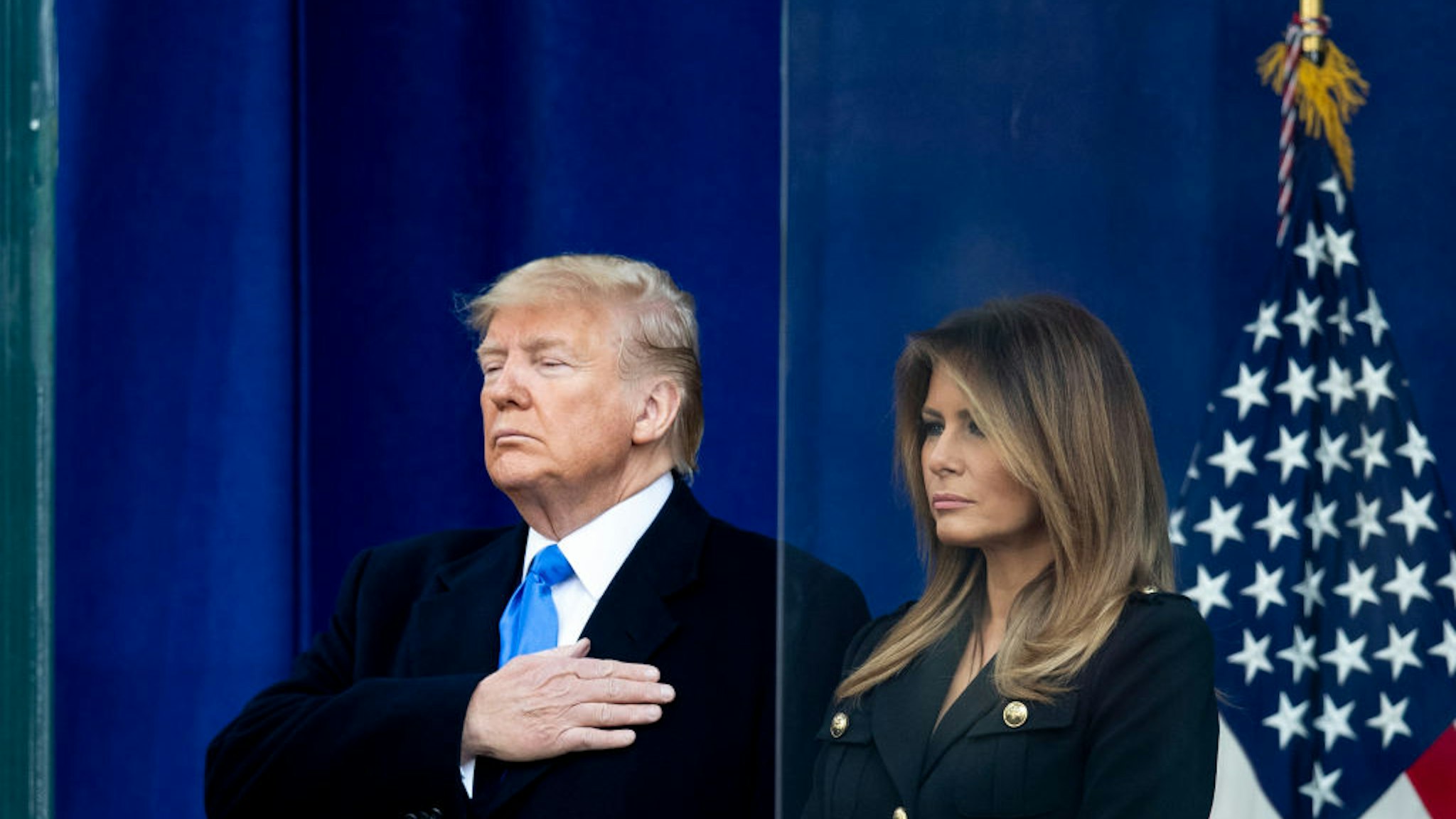 The 45th President Donald J. Trump with his had on his heart and the First Lady Melania Trump with her arms at her side after he addressed the crowd during his opening ceremony of the New York City 100th annual Veterans Day Parade and wreath-laying at the Eternal Light Flag Staff.