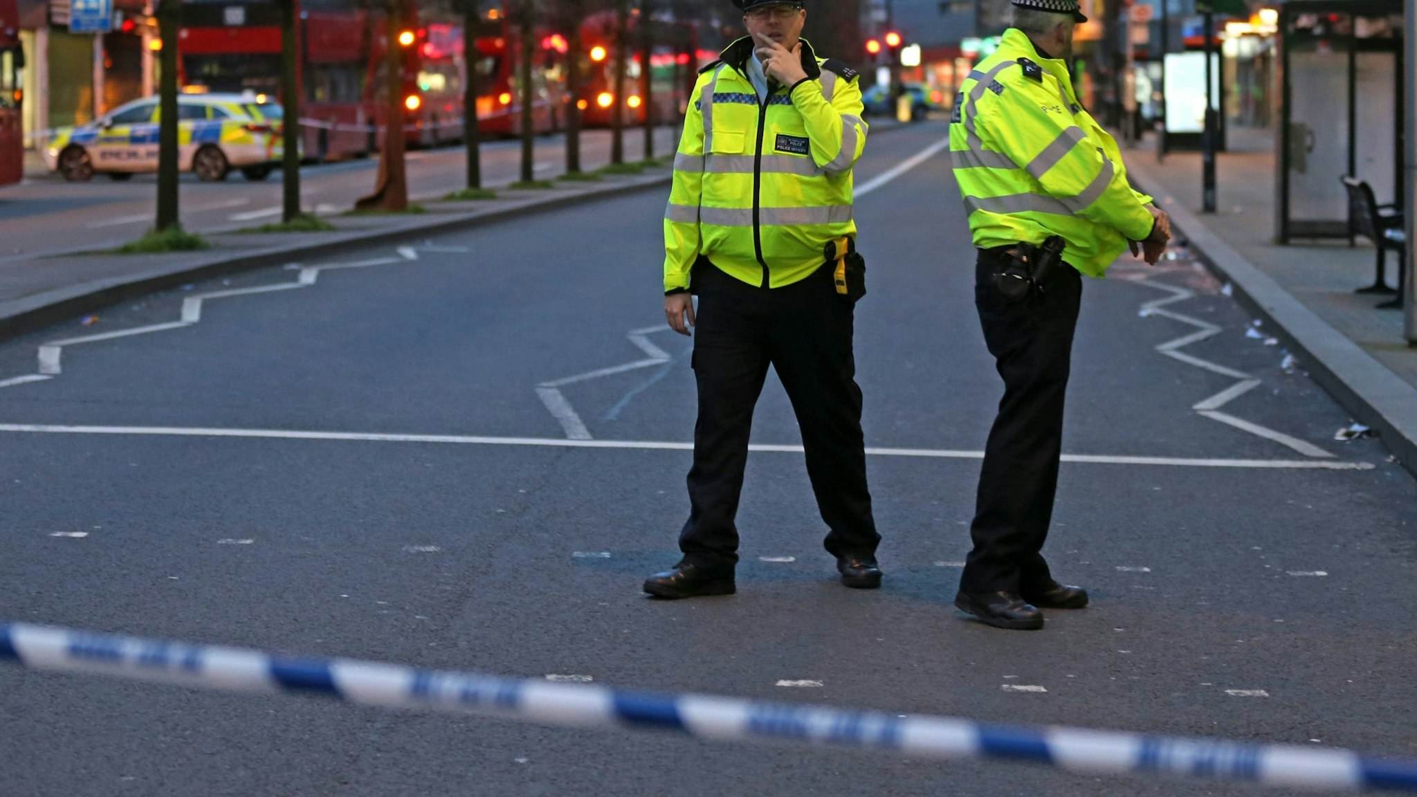 Police officers guard a cordon, set up on Streatham High Road, at the junction of Woodbourne Road, in south London on February 2, 2020, after a man is shot dead by police following reports of people being stabbed in the street. - British police on Sunday said they had shot a man in south London, after at least two people were stabbed in a suspected "terrorist-related" incident. (Photo by ISABEL INFANTES / AFP) (Photo by ISABEL INFANTES/AFP via Getty Images)