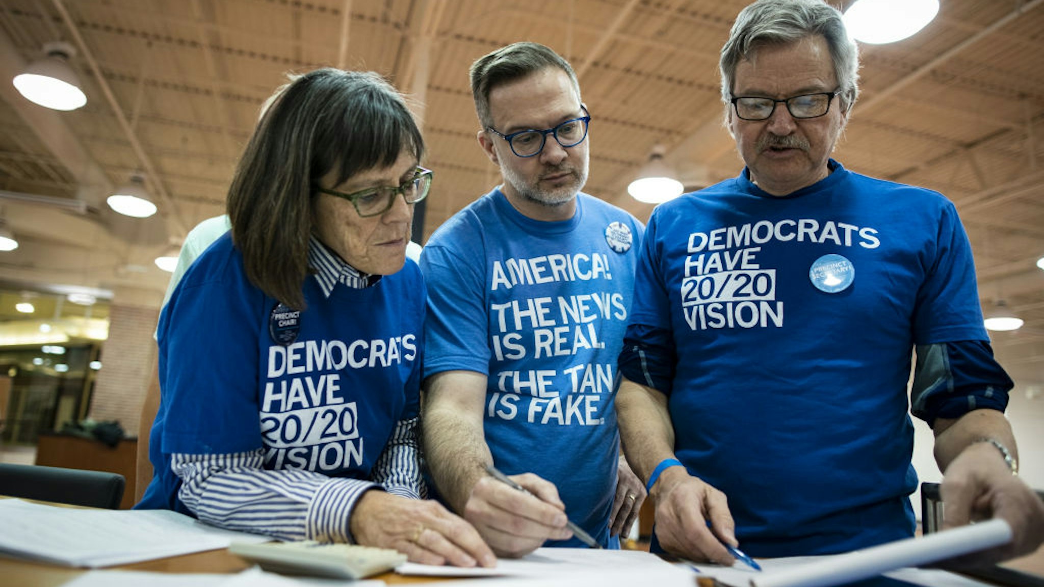Volunteers tally votes during the first-in-the-nation Iowa caucus at the Southridge Mall in Des Moines, Iowa, U.S., on Monday, Feb. 3, 2020.