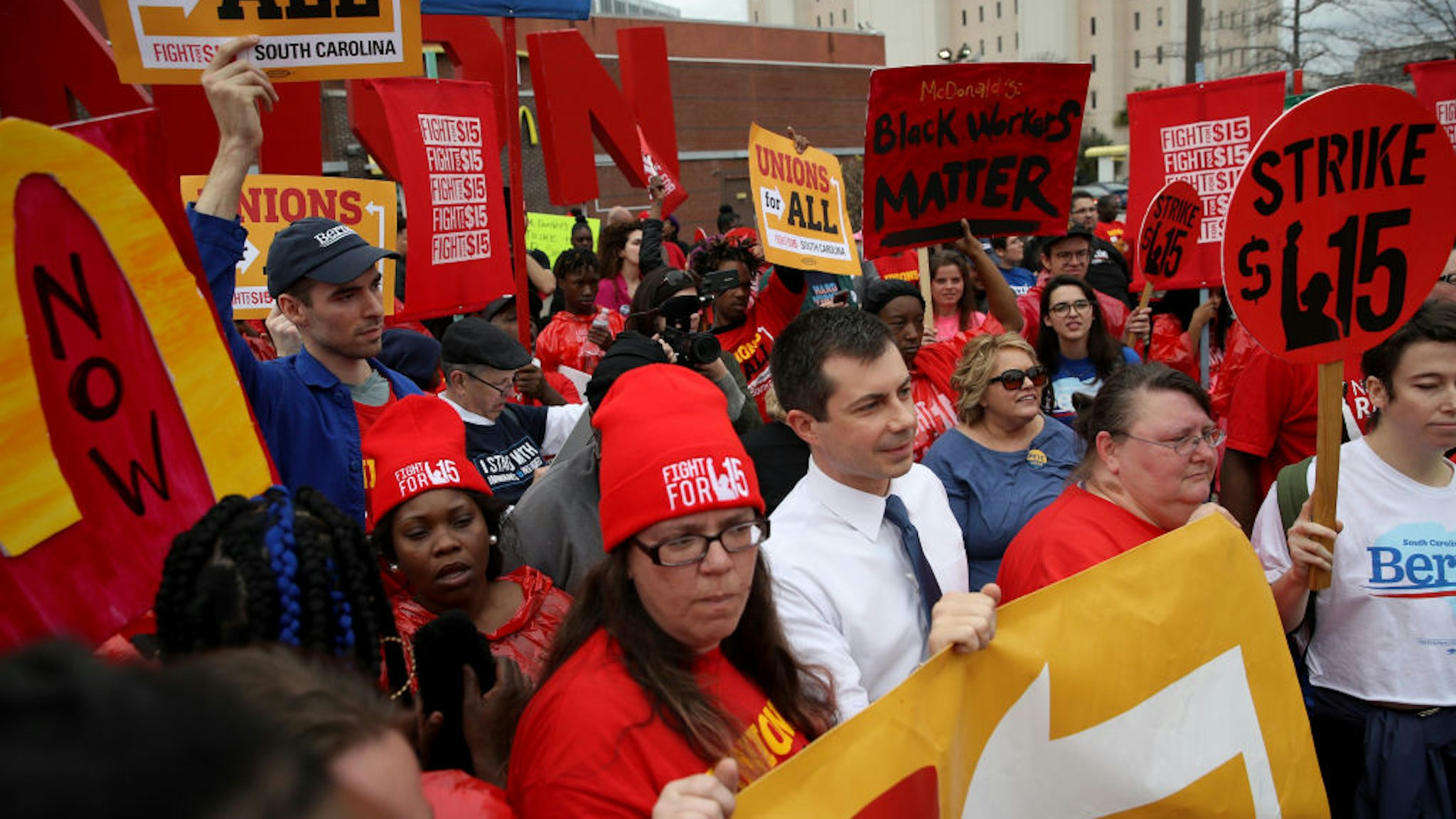 Democratic presidential candidate former South Bend, Indiana Mayor Pete Buttigieg marches with South Carolina McDonald’s workers as they demonstrate for a $15 an hour wage and the right to form a workers union February 24, 2020 in Charleston, South Carolina.