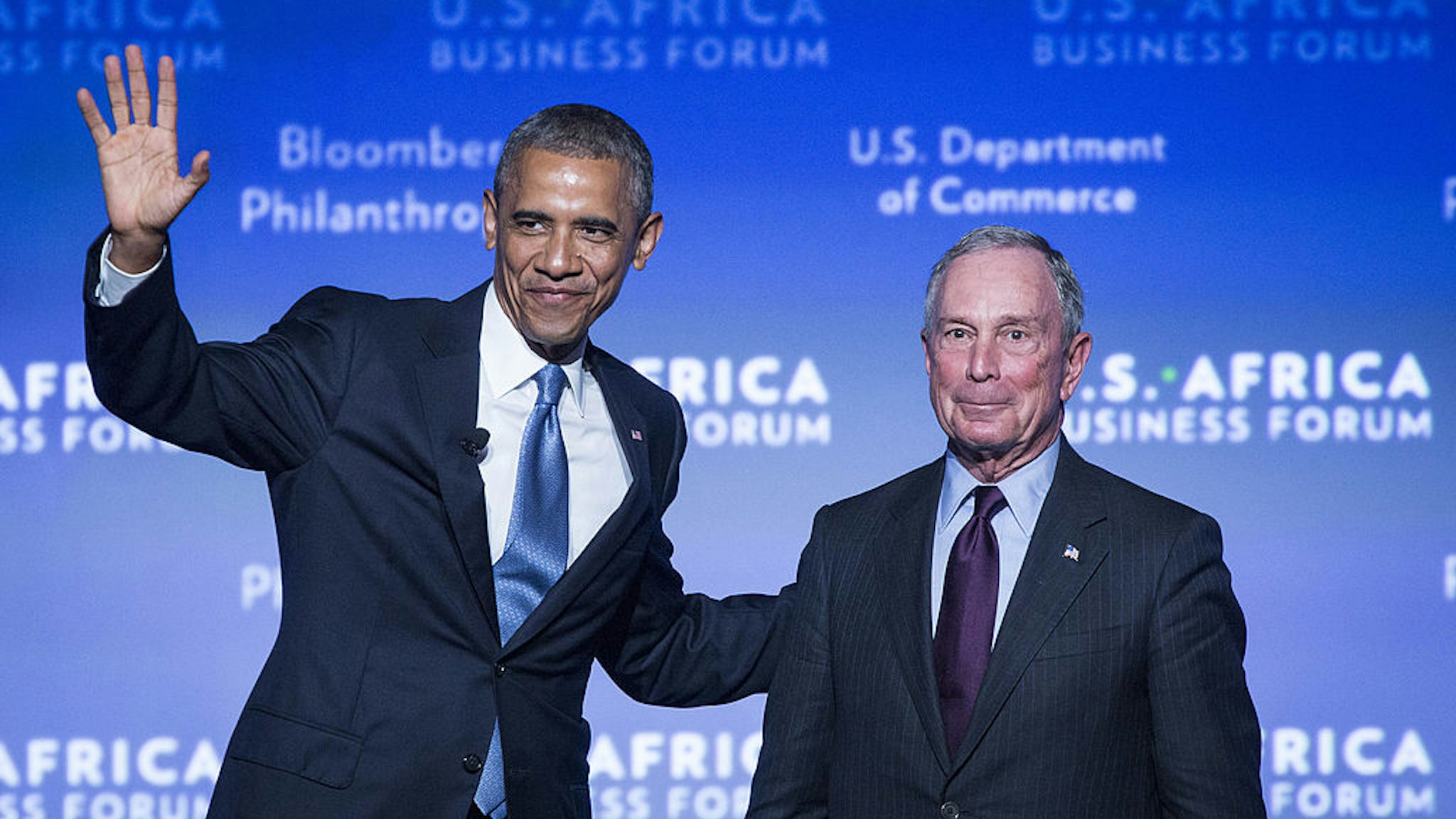 U.S. President Barack Obama, left, waves to the audience after being introduced by Michael Bloomberg, former mayor of New York, at the US-Africa Business Forum in Washington, D.C., U.S., on Tuesday, Aug. 5, 2014.
