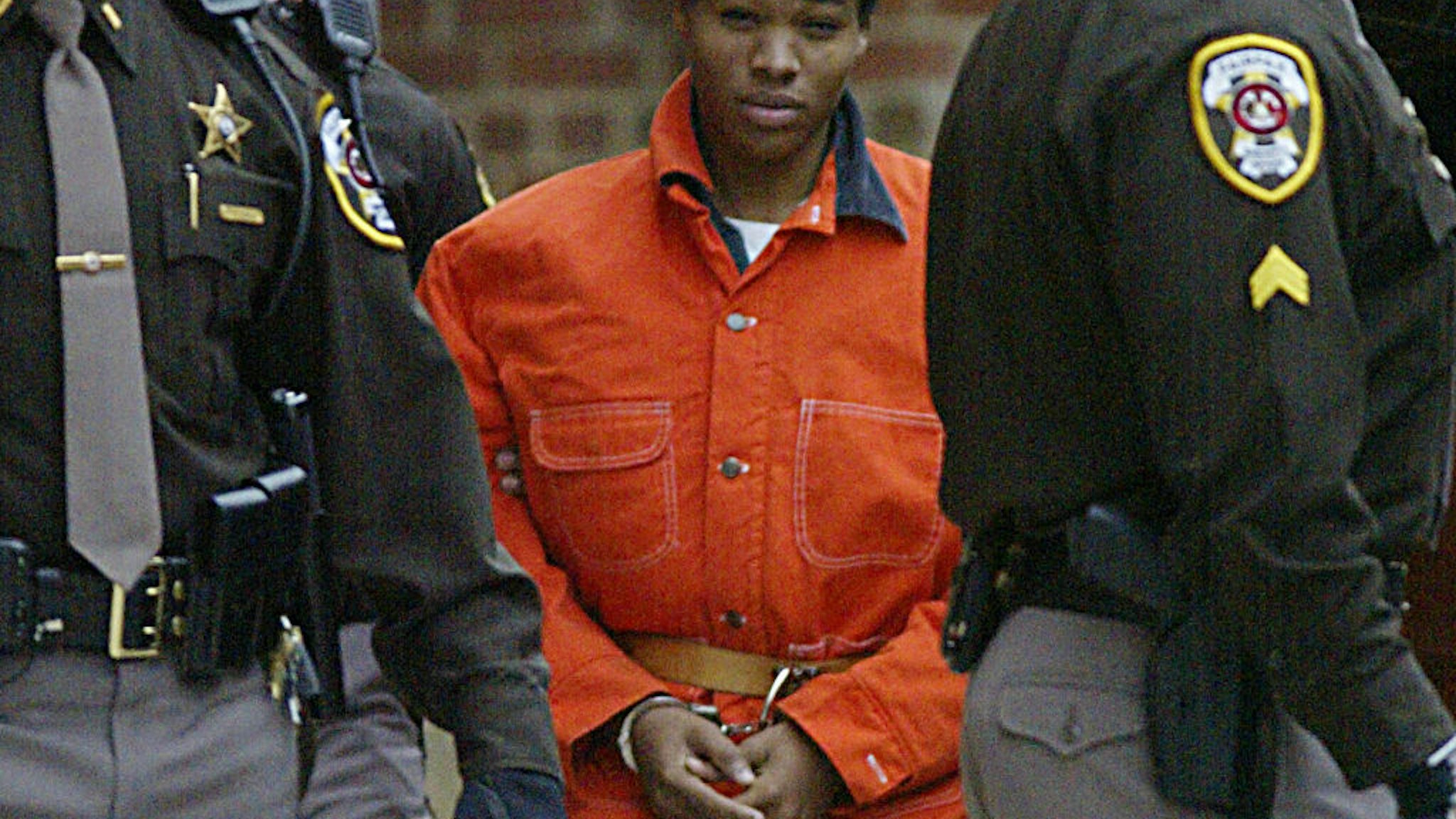 Sniper suspect Lee Malvo (c) leaves a pre-trial hearing at the Fairfax County Juvenile and Domestic Relations Court 04 December 2002 in Fairfax, Virginia.