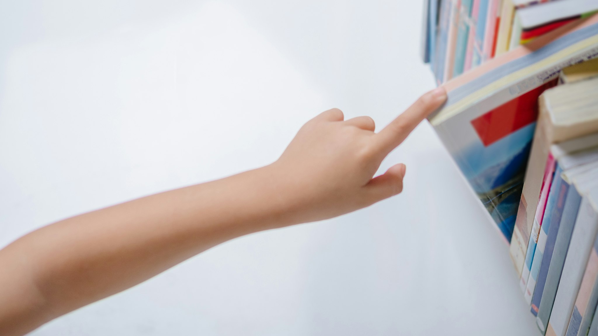 Child reaching for book