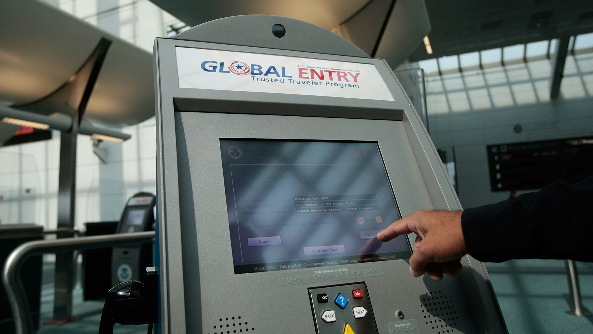 EWARK, NJ - AUGUST 24: An officer with the US Customs and Border Protection demonstrates a new arrivals processing kiosk at Newark International Airport August 24, 2009 in Newark, New Jersey. Officials with U.S. Customs and Border Protection are introducing are introducing the Global Entry program, which allows pre-screening and approval of travelers and faster trips through customs and passport lines upon arriving into the United States. (Photo by Chris Hondros/Getty Images)