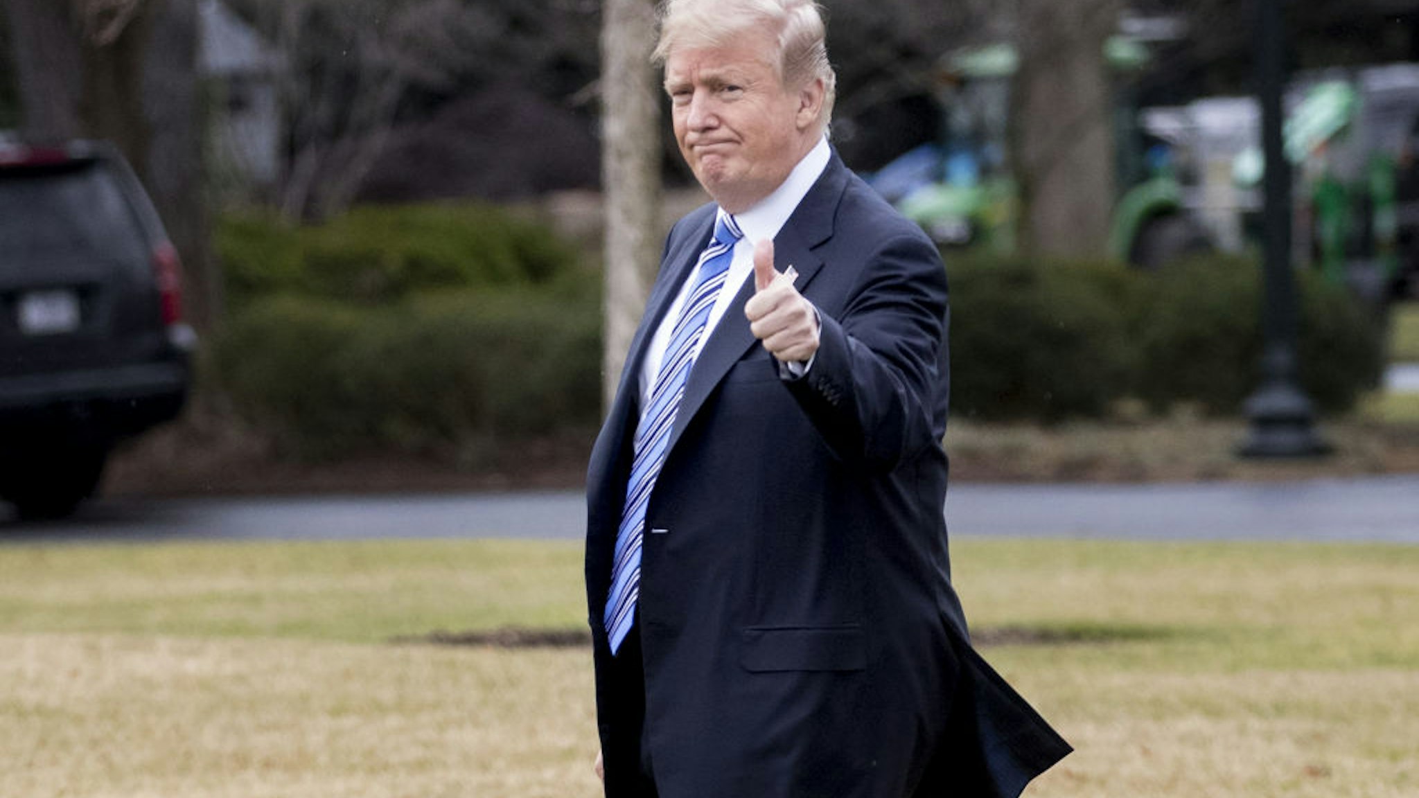 U.S. President Donald Trump gives a thumbs-up while walking on the South Lawn of the White House toward Marine One in Washington, D.C., U.S., on Friday, Feb. 16, 2018.