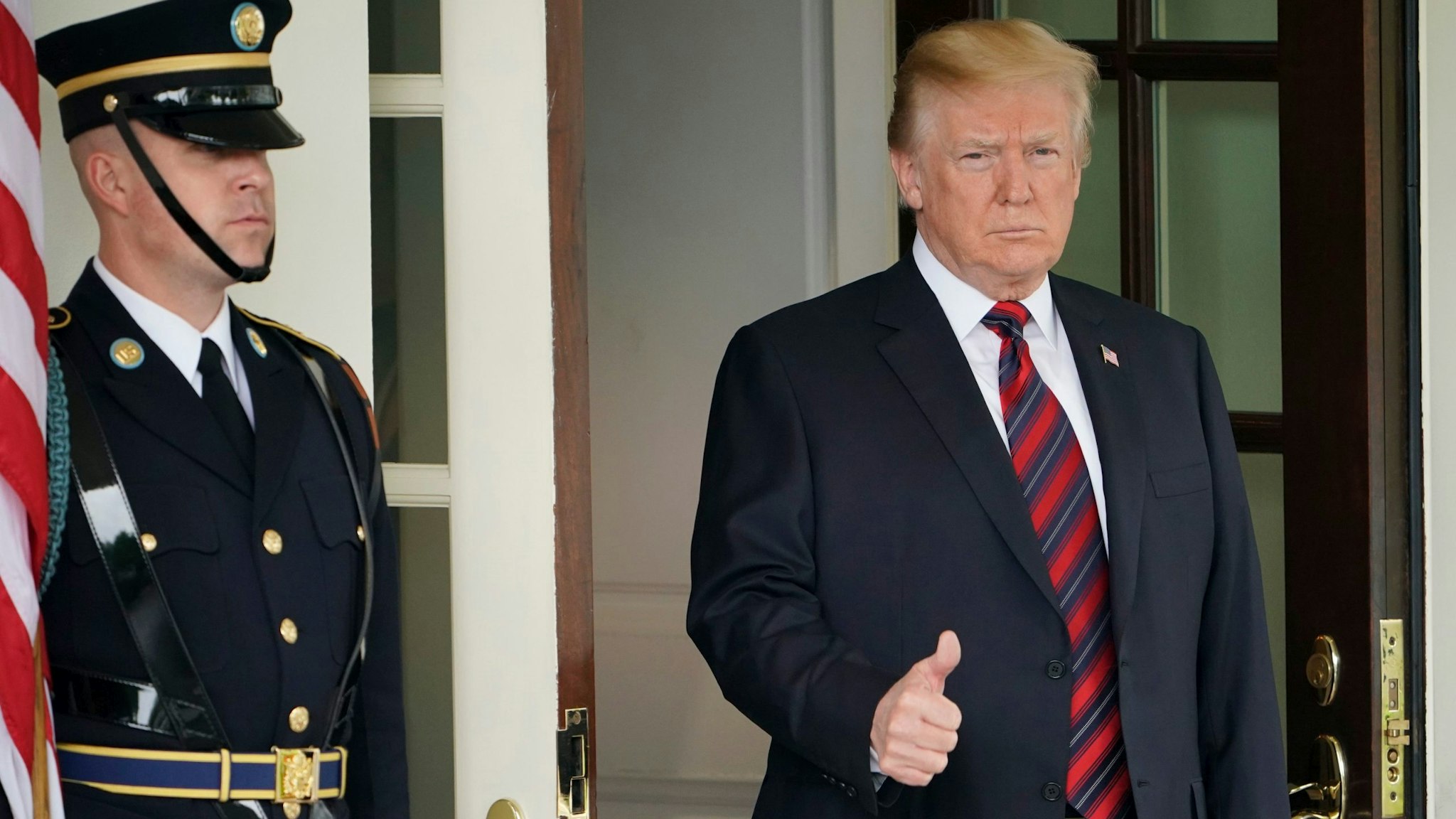 US President Donald Trump gives the thumbs-up as he awaits the arrival of South Korea's President Moon Jae-in outside of the West Wing of the White House on May 22, 2018 in Washington, DC. - Donald Trump welcomed South Korea's president to the White House Tuesday, a high stakes and potentially testy meeting that could decide whether the US leader's much-vaunted summit with Kim Jong Un goes ahead. (Photo by Mandel Ngan / AFP) (Photo credit should read MANDEL NGAN/AFP via Getty Images)