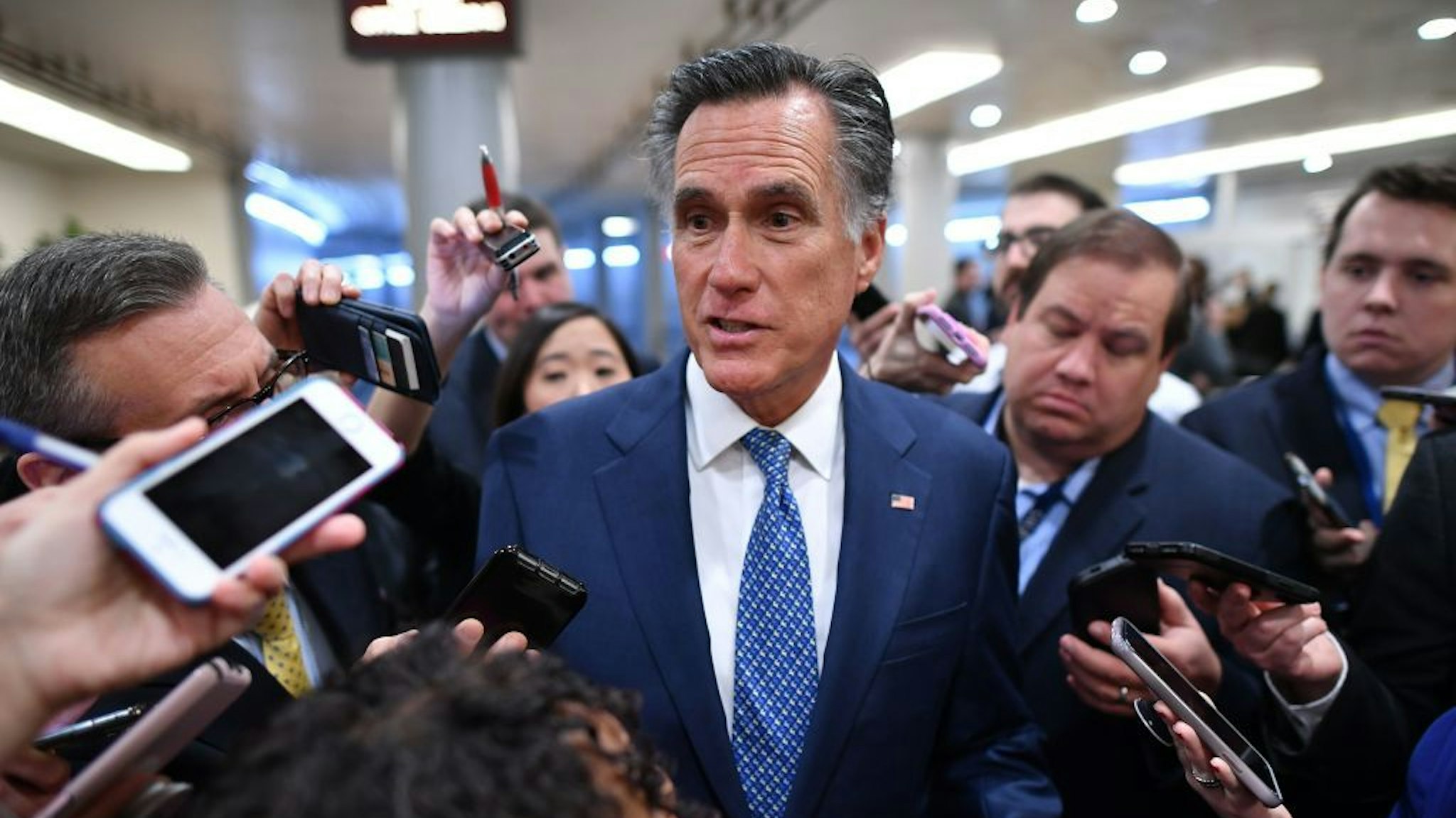 Senator Mitt Romney(R-UT)speaks to the media as he arrives during the impeachment trial of US President Donald Trump on Capitol Hill January 29, 2020, in Washington, DC. - The fight over calling witnesses to testify in President Donald Trump's impeachment trial intensified January 28, 2020 after Trump's lawyers closed their defense calling the abuse of power charges against him politically motivated. Democrats sought to have the Senate subpoena former White House national security advisor John Bolton to provide evidence after leaks from his forthcoming book suggested he could supply damning evidence against Trump. . (Photo by Mandel NGAN / AFP)