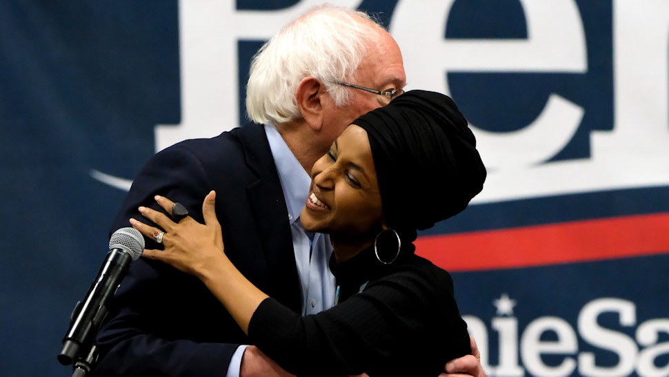 MANCHESTER, UNITED STATES - 2019/12/13: Vermont Senator and presidential candidate Bernie Sanders and Minnesota Congresswoman Ilhan Omar embrace each other during the campaigns at Southern New Hampshire University in Manchester.