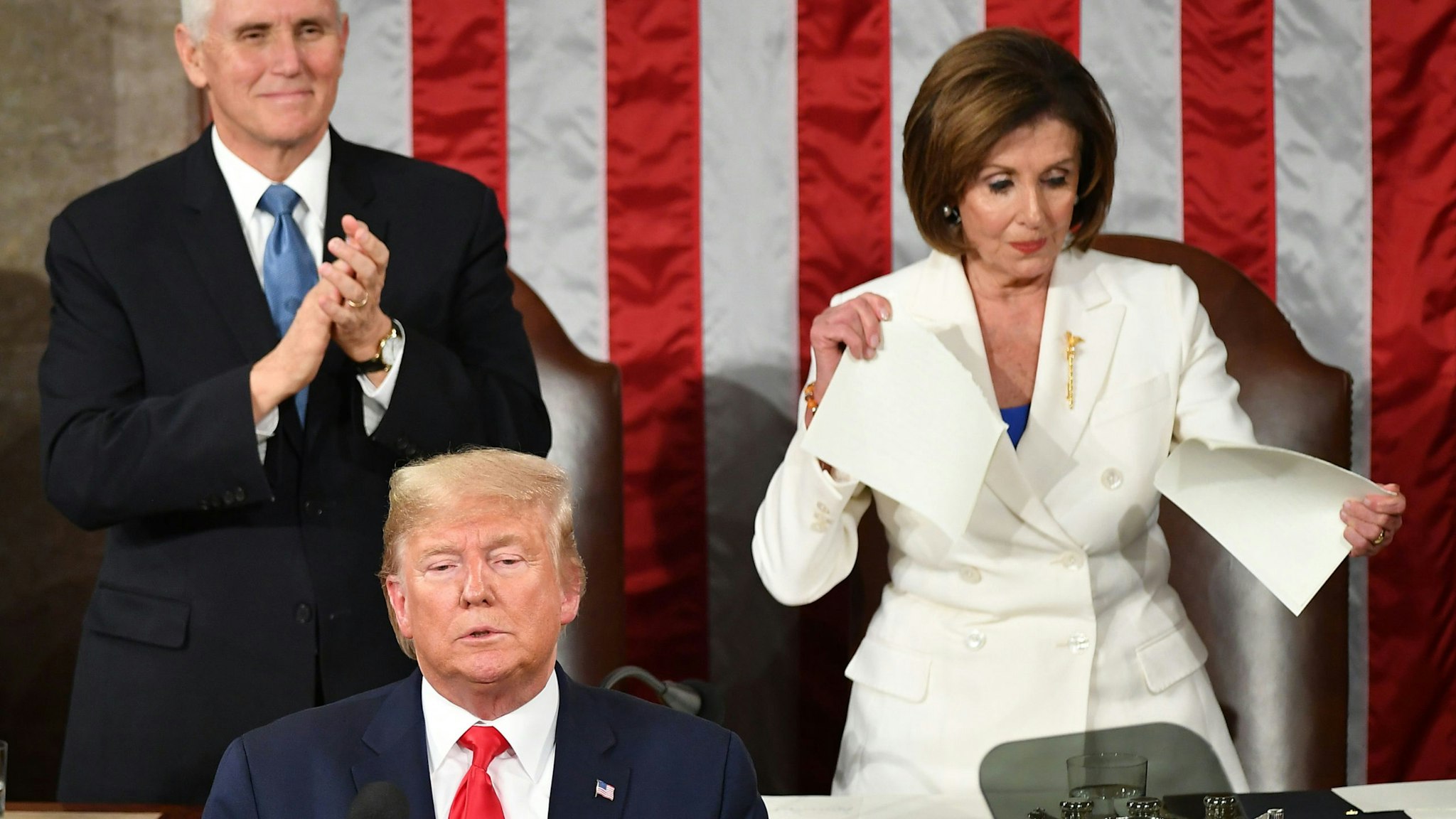US Vice President Mike Pence claps as Speaker of the US House of Representatives Nancy Pelosi appears to rip a copy of US President Donald Trumps speech after he delivers the State of the Union address at the US Capitol in Washington, DC, on February 4, 2020.