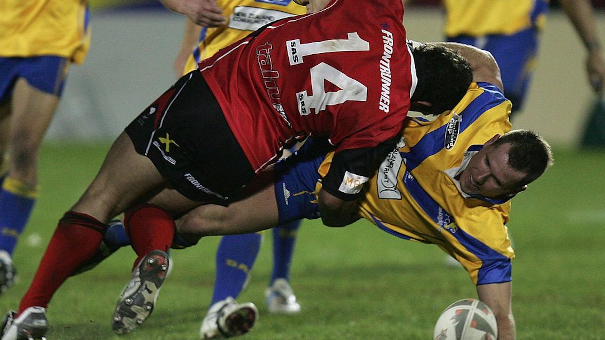 Rowan Baxter of the Lions tackled by Clinton Fraser (L) during the NZRL National Premiership Bartercard Cup Grand Final league match between the Auckland Lions and Canterbury Bulls played at Mount Smart Stadium on September 18, 2006 in Auckland New Zealand.