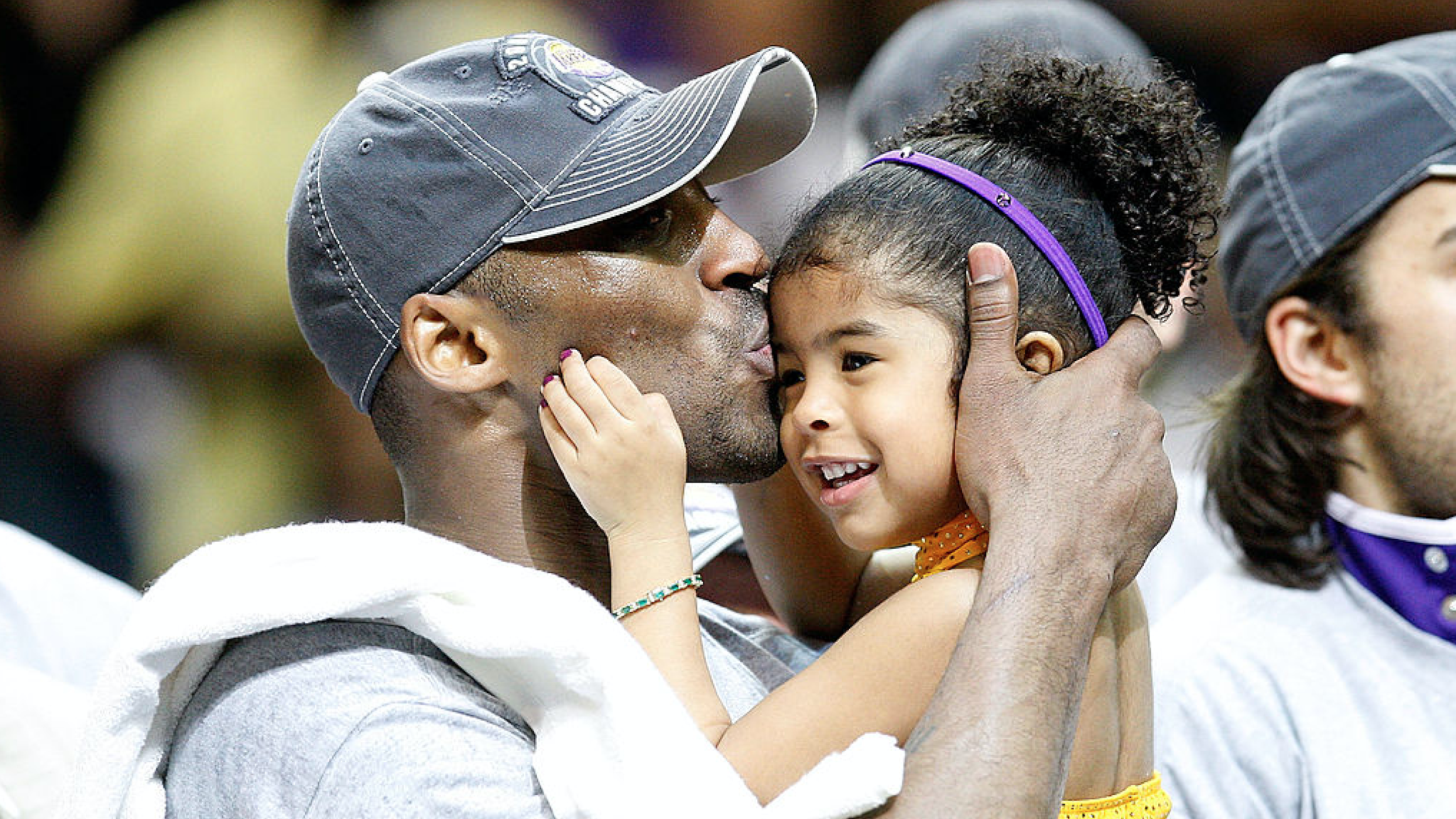Kobe Bryant #24 of the Los Angeles Lakers kisses his daughter, Gianna, after the Lakers defeated the Orlando Magic 99-86 in Game Five of the 2009 NBA Finals on June 14, 2009 at Amway Arena in Orlando, Florida.