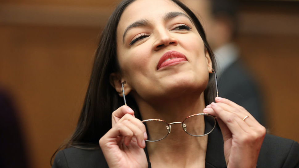 House Financial Services Committee member Rep. Alexandria Ocasio-Cortez (D-NY) puts on her glasses as the committee takes a break in the testimony of Facebook co-founder and CEO Mark Zuckerberg in the Rayburn House Office Building on Capitol Hill October 23, 2019 in Washington, DC