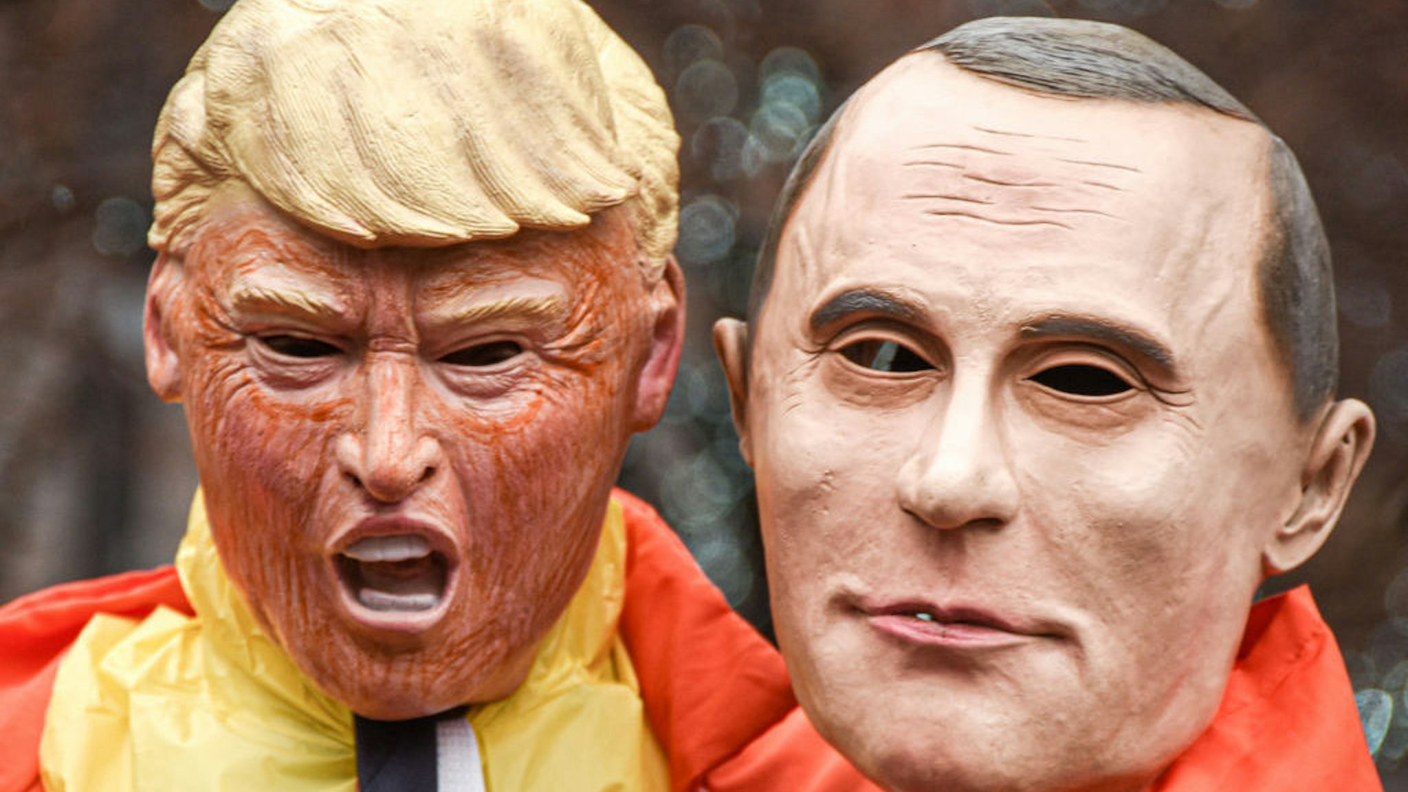 A protester dressed as the United States President Donald Trump holds a mask of Russian President Vladimir Putin during the march. Women's March is an annual event that is held across the United States every year to honour women's rights. There were marches in many cities across our country this afternoon, and they were attended by women's rights activists, politicians, and citizens, alike. (Photo by Whitney Saleski/SOPA Images/LightRocket via Getty Images)